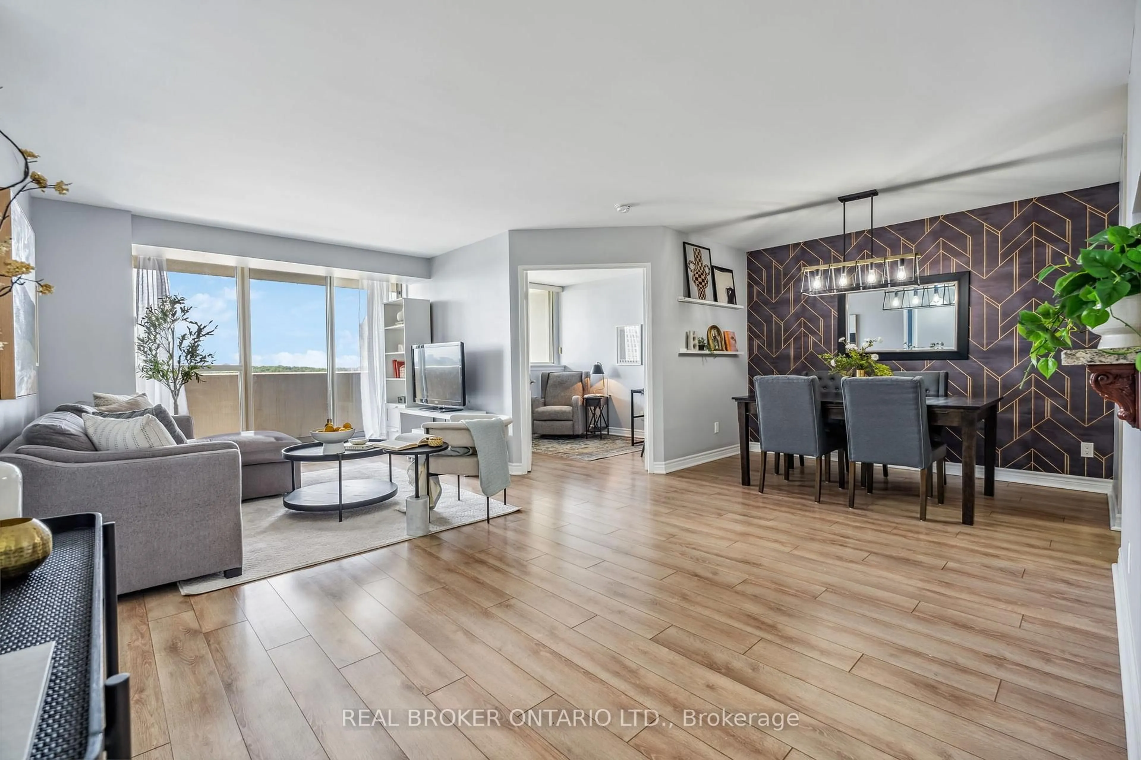 Living room with furniture, wood/laminate floor for 30 Thunder Grve #1102, Toronto Ontario M1V 4A3