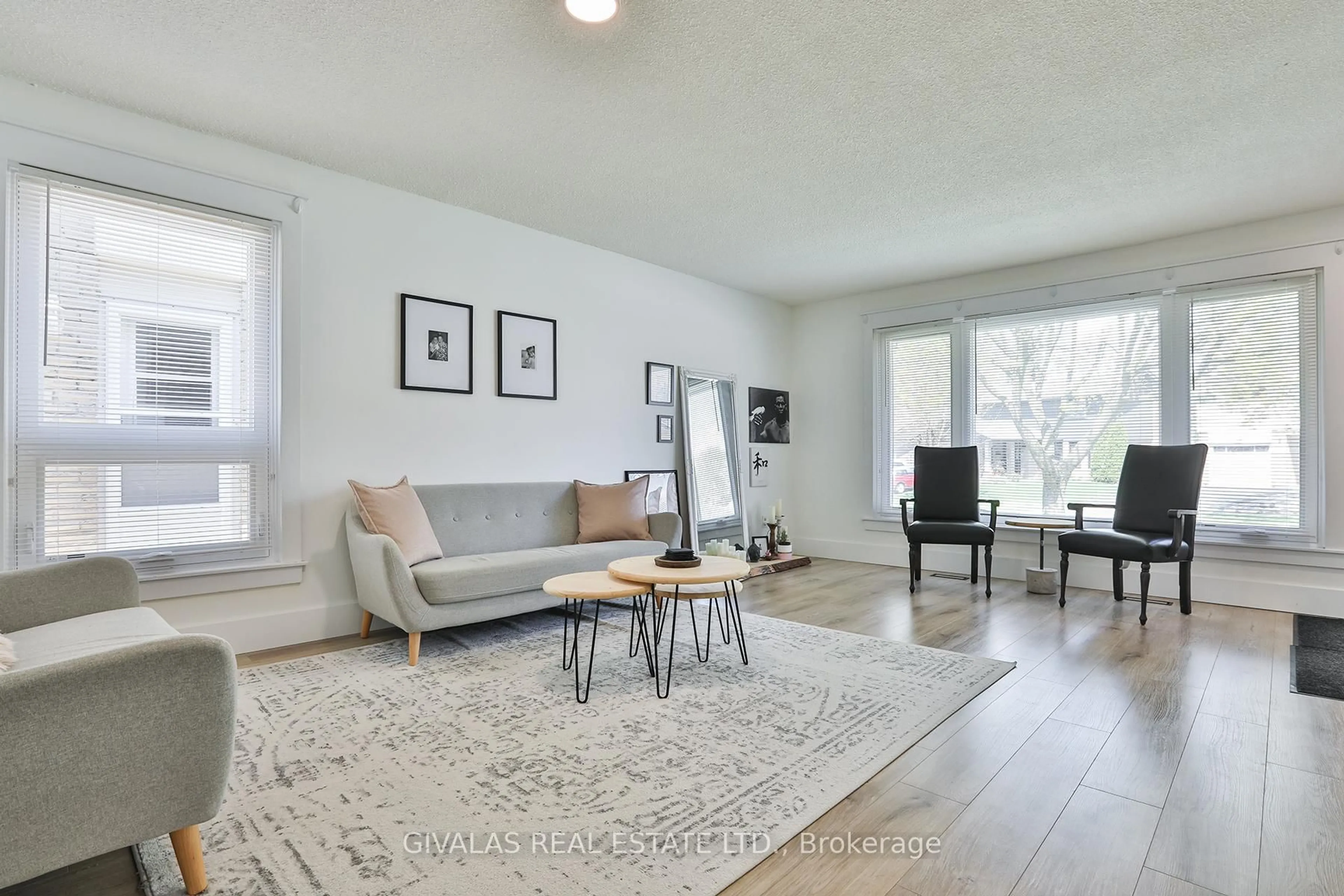 Living room with furniture, wood/laminate floor for 574 Bradley Dr, Whitby Ontario L1N 6C2