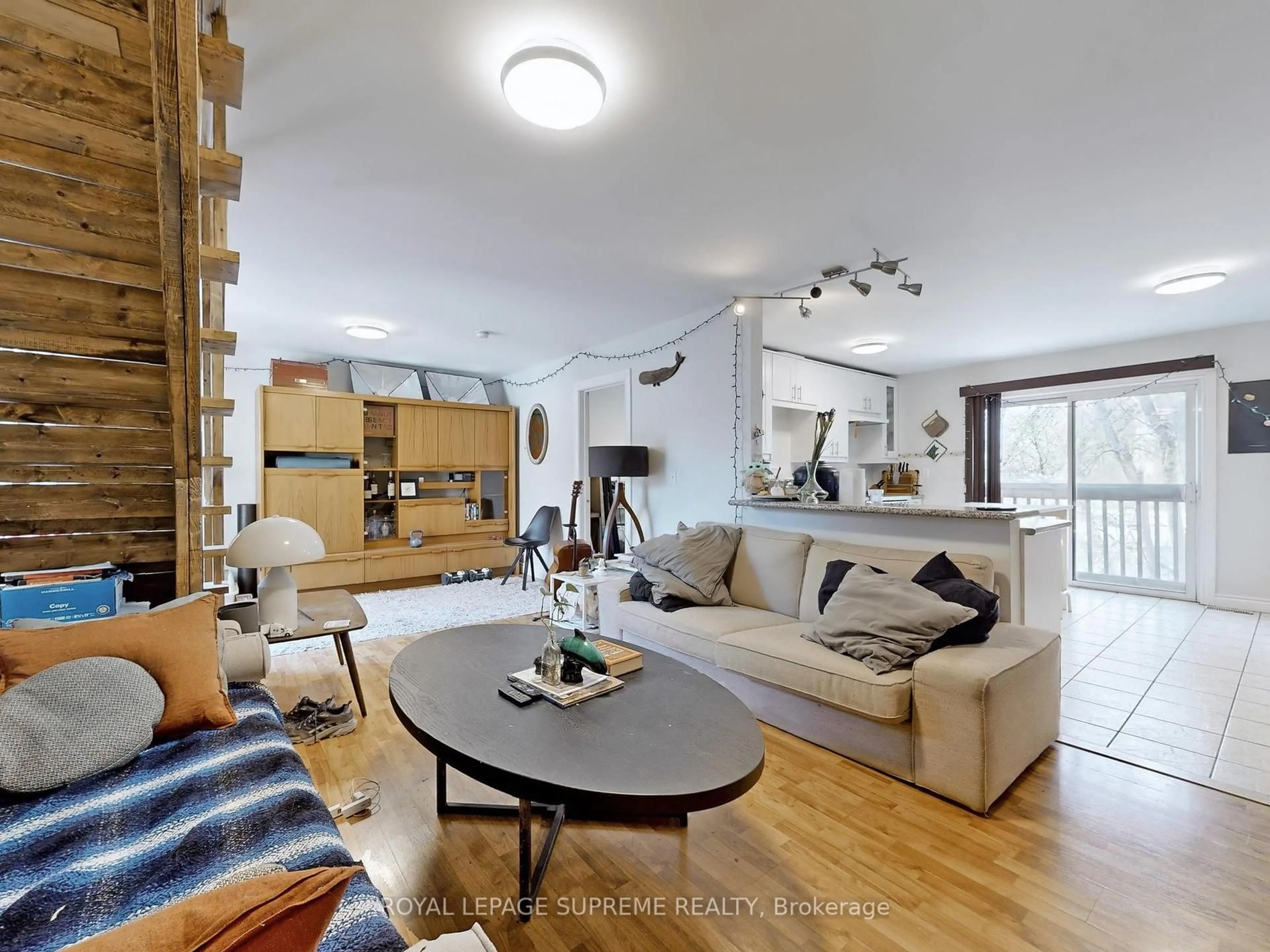 Living room with furniture, wood/laminate floor for 370 Jones Ave, Toronto Ontario M4J 3G3