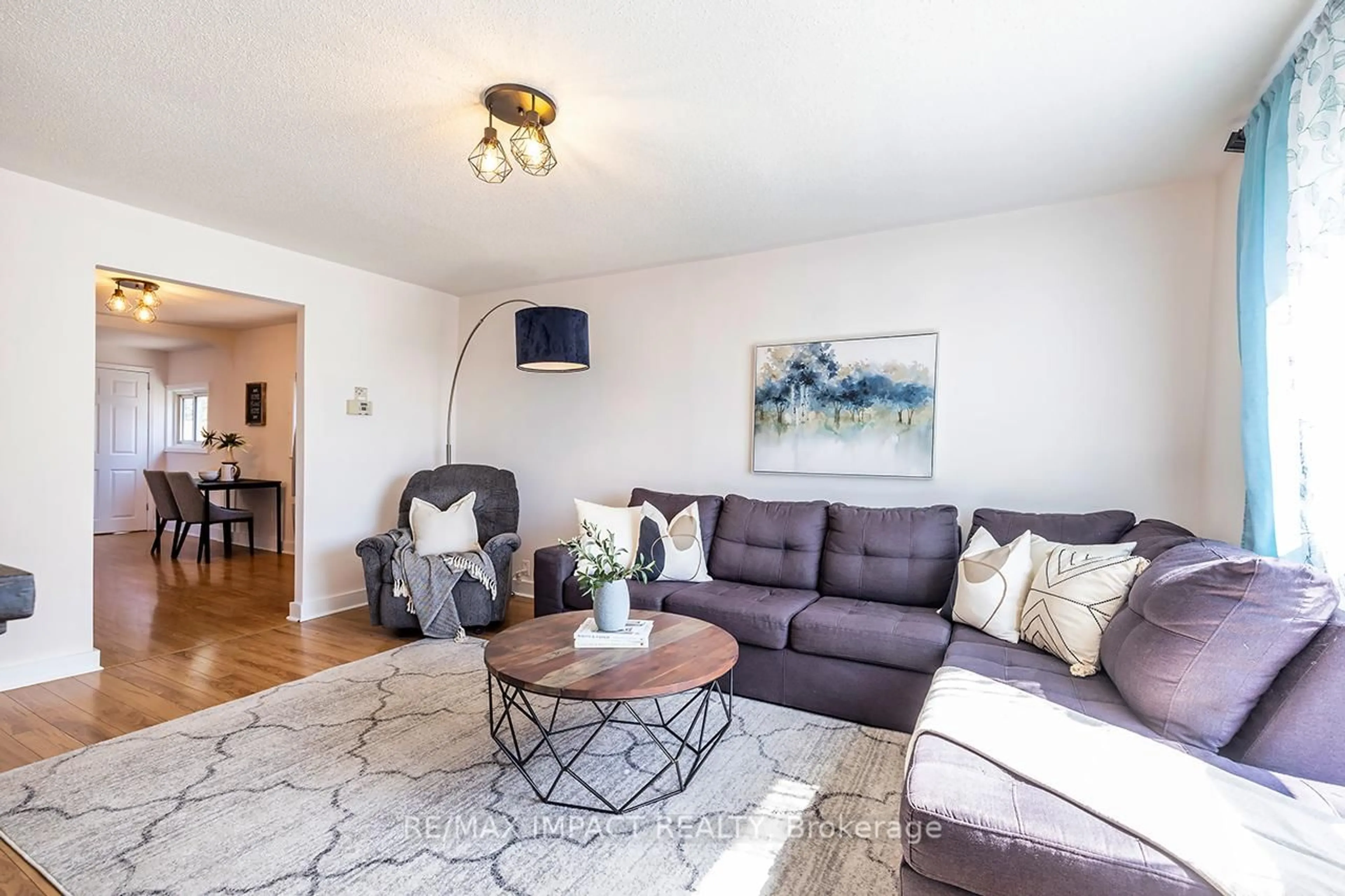 Living room with furniture, wood/laminate floor for 211 James St, Oshawa Ontario L1H 4Y4