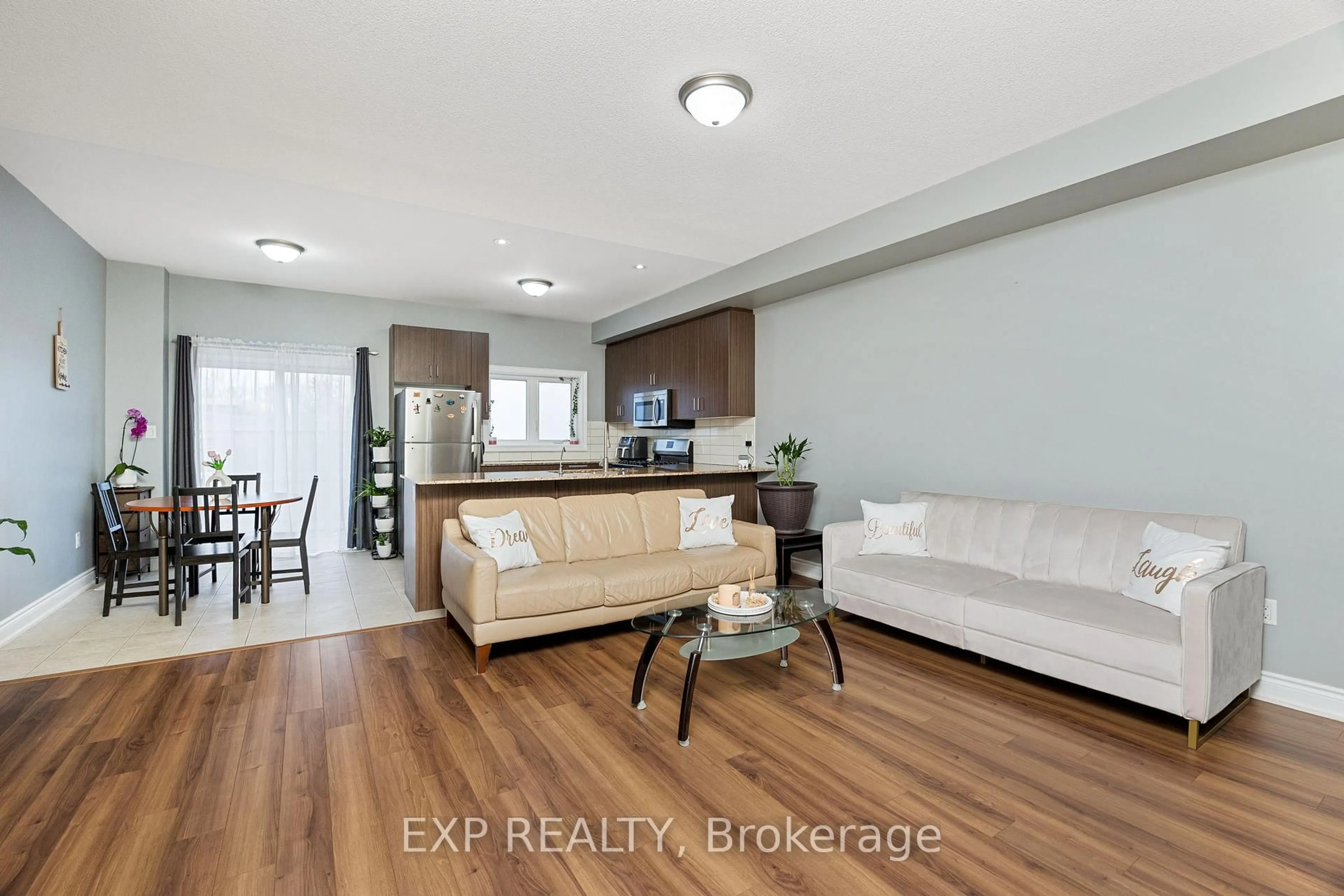 Living room with furniture, wood/laminate floor for 34 Prospect Way, Whitby Ontario L1N 0L4