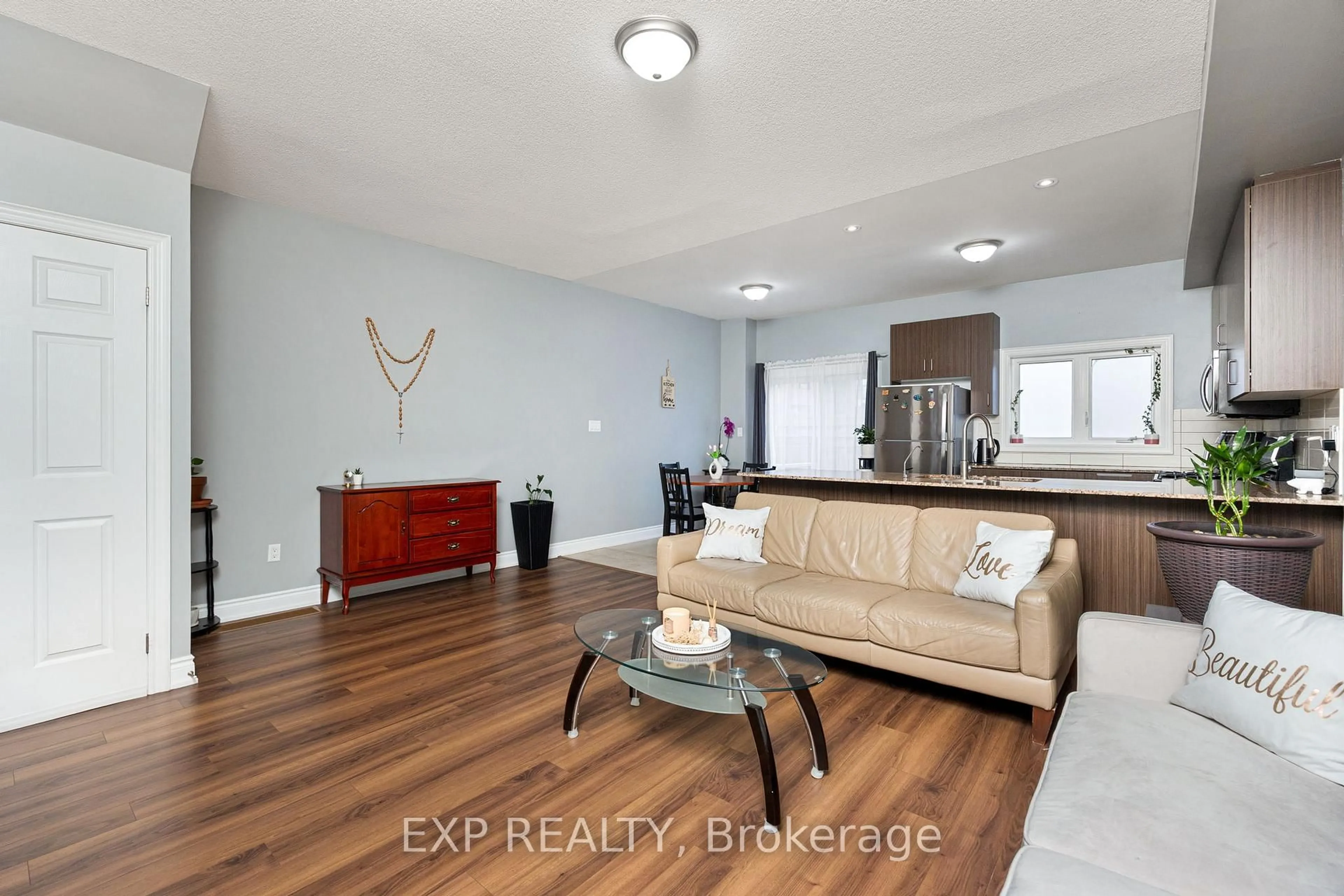 Living room with furniture, wood/laminate floor for 34 Prospect Way, Whitby Ontario L1N 0L4