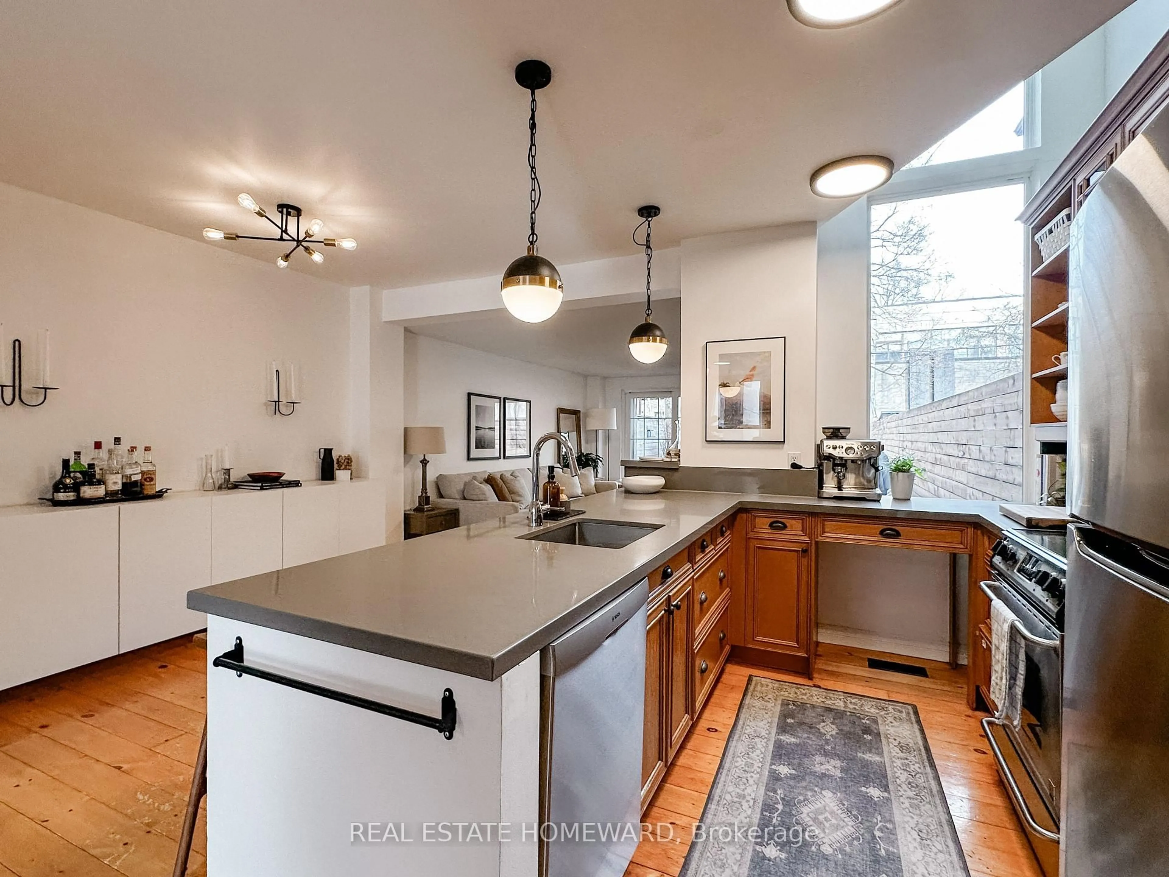Open concept kitchen, cement floor for 211 Hamilton St, Toronto Ontario M4M 2E3