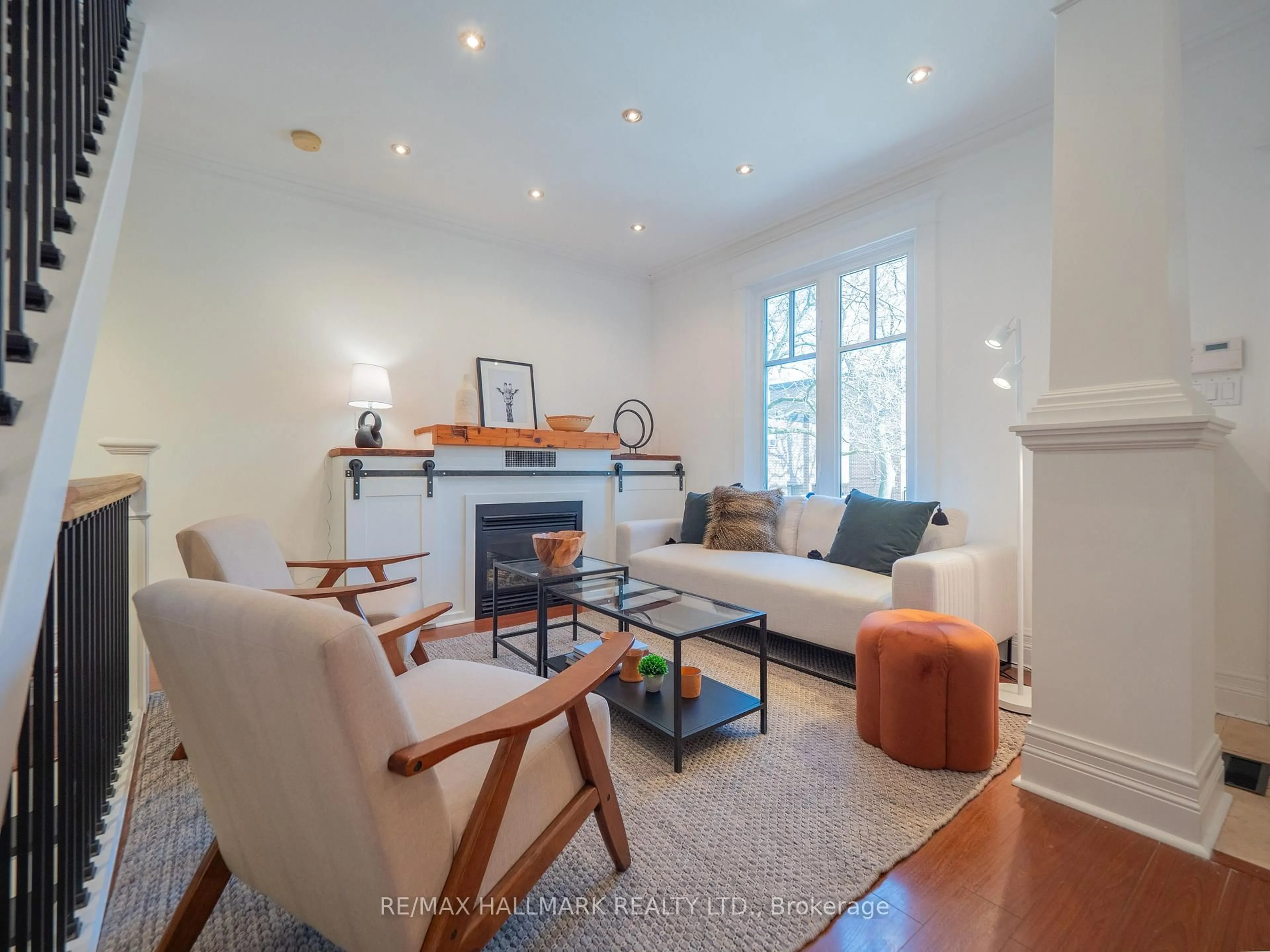 Living room with furniture, wood/laminate floor for 338 Bain Ave, Toronto Ontario M4J 1B8