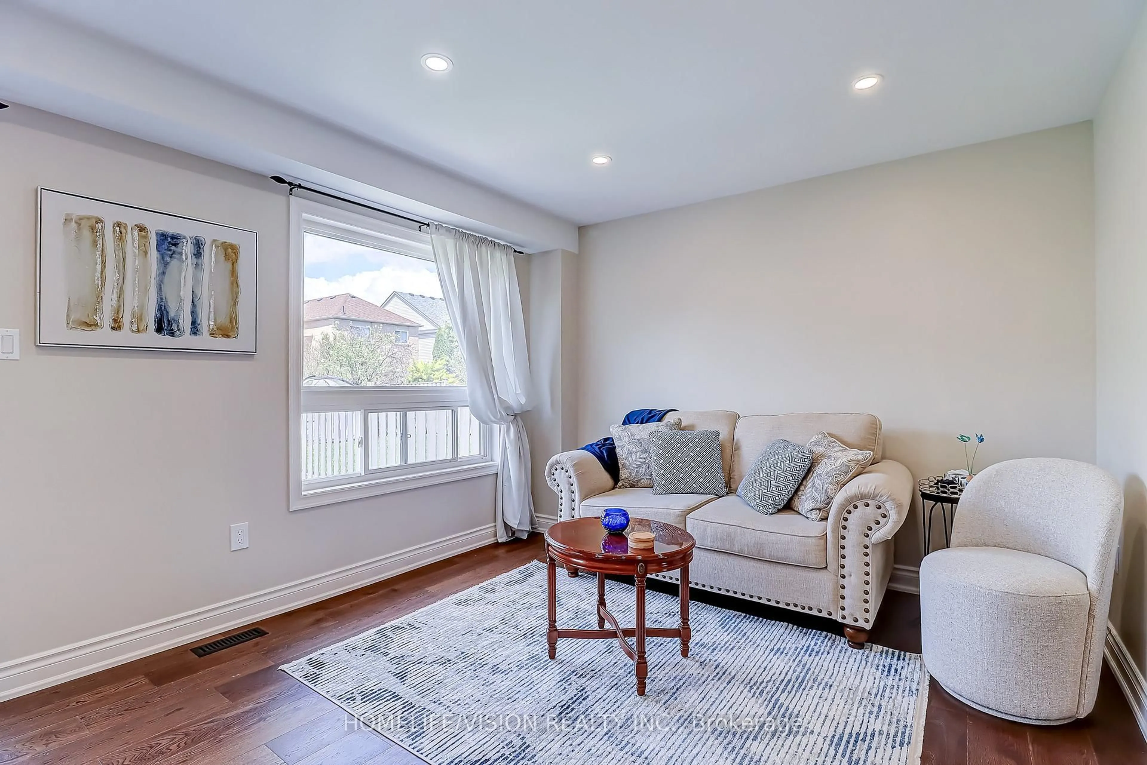 Living room with furniture, wood/laminate floor for 28 Longueuil Pl, Whitby Ontario L1R 3G9