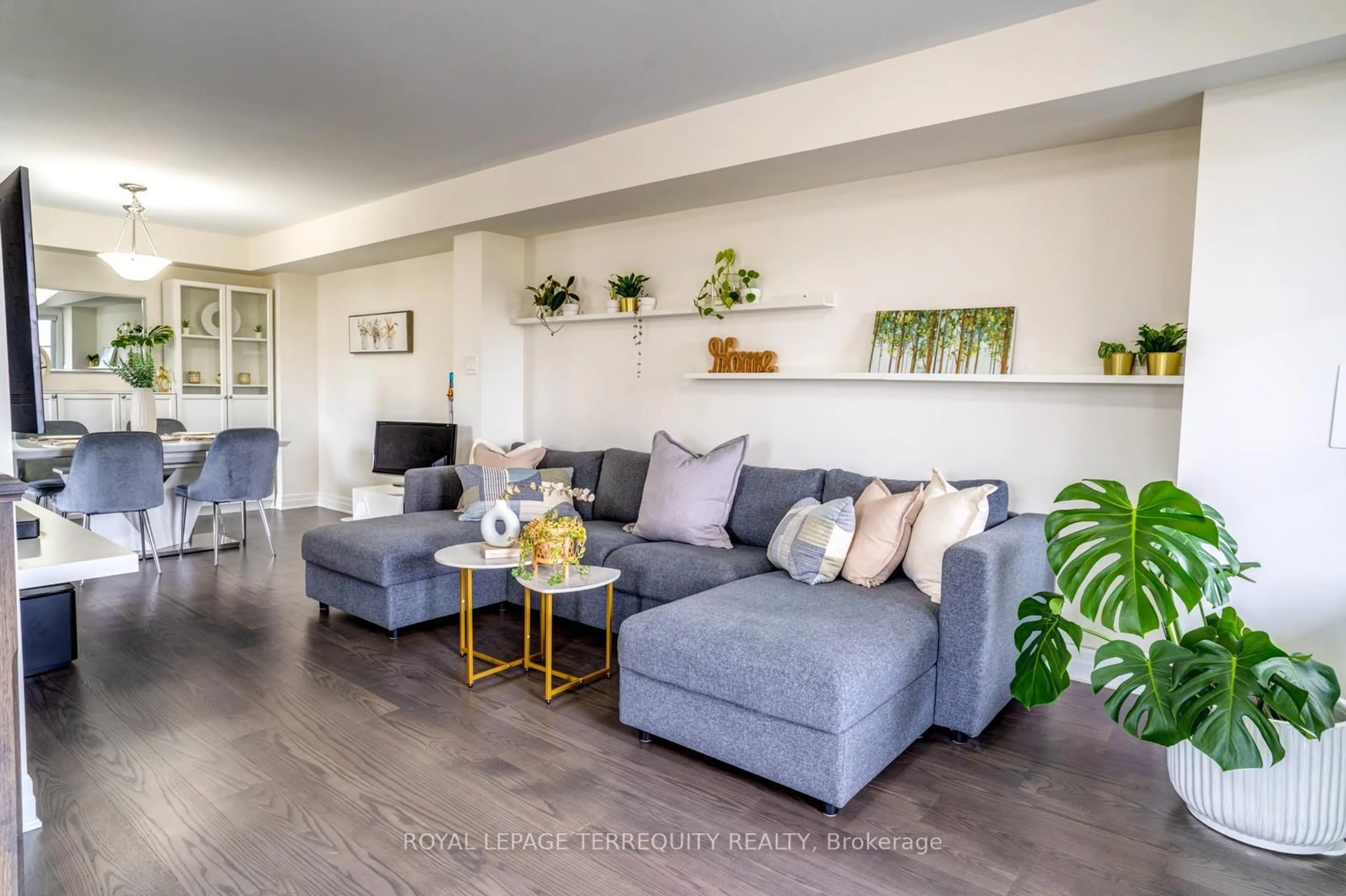 Living room with furniture, wood/laminate floor for 72 Fusilier Dr, Toronto Ontario M1L 0J3