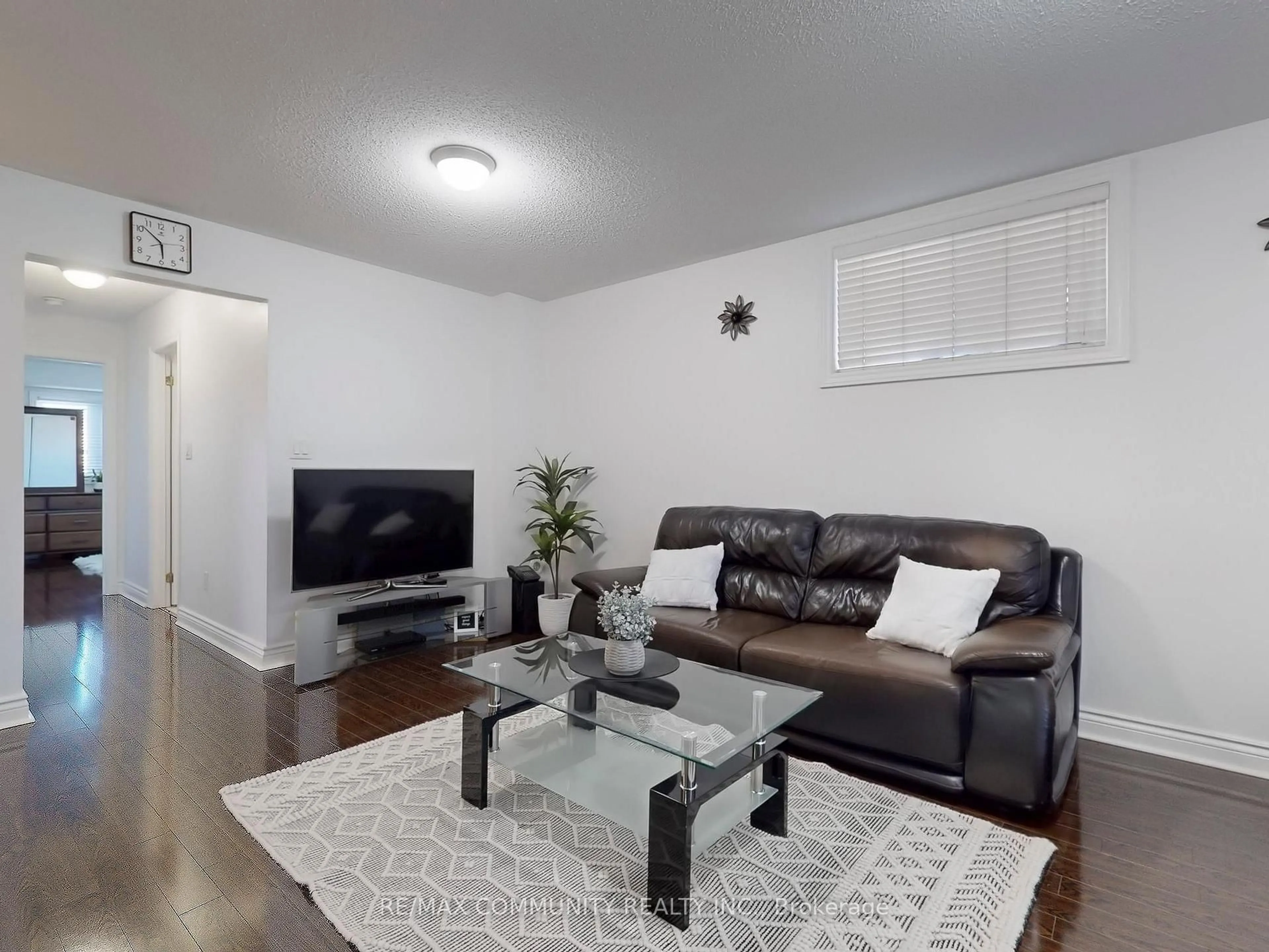 Living room with furniture, wood/laminate floor for 1785 Markham Rd #101, Toronto Ontario M1B 2Z7