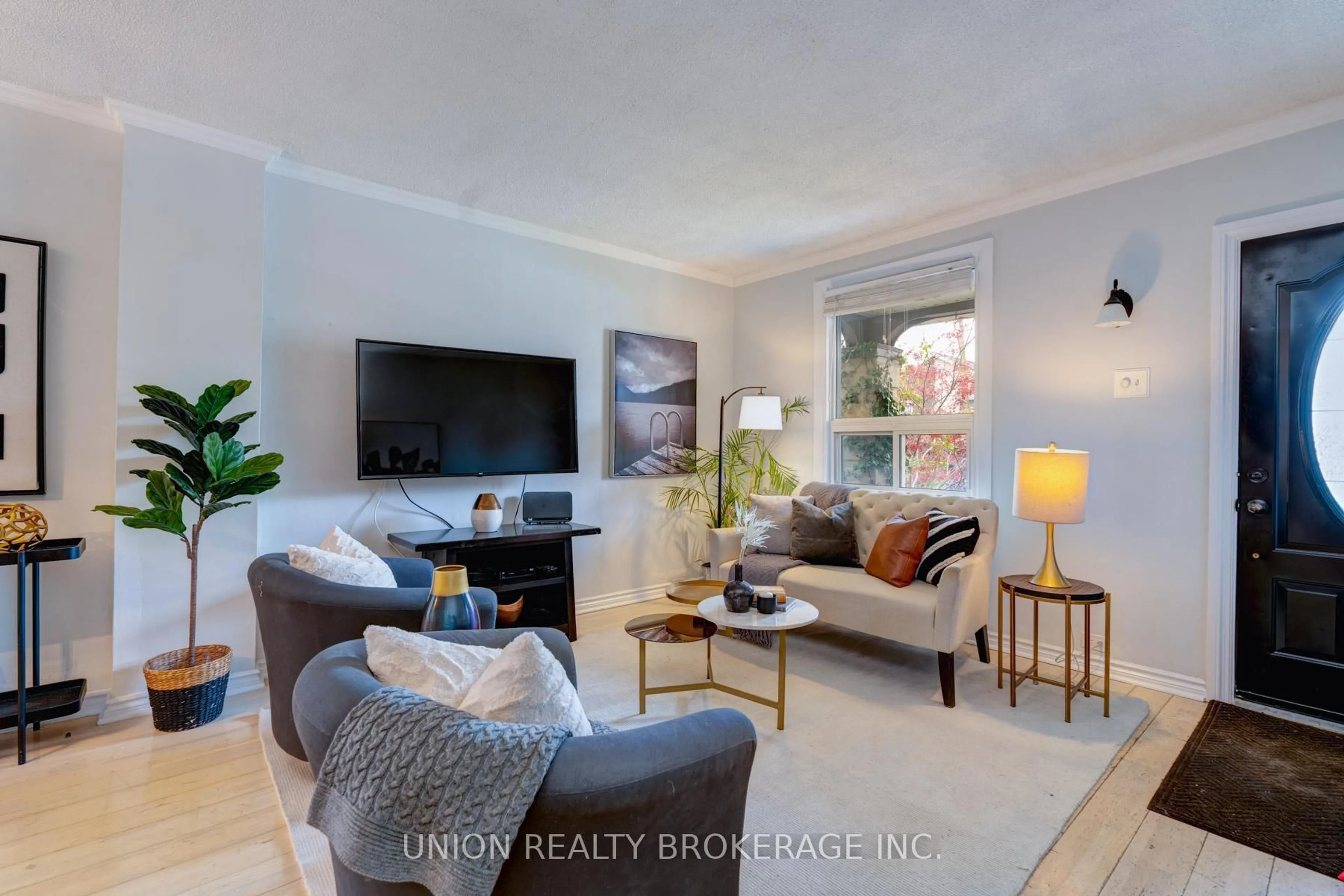 Living room with furniture, wood/laminate floor for 11 Roseheath Ave, Toronto Ontario M4C 3P3