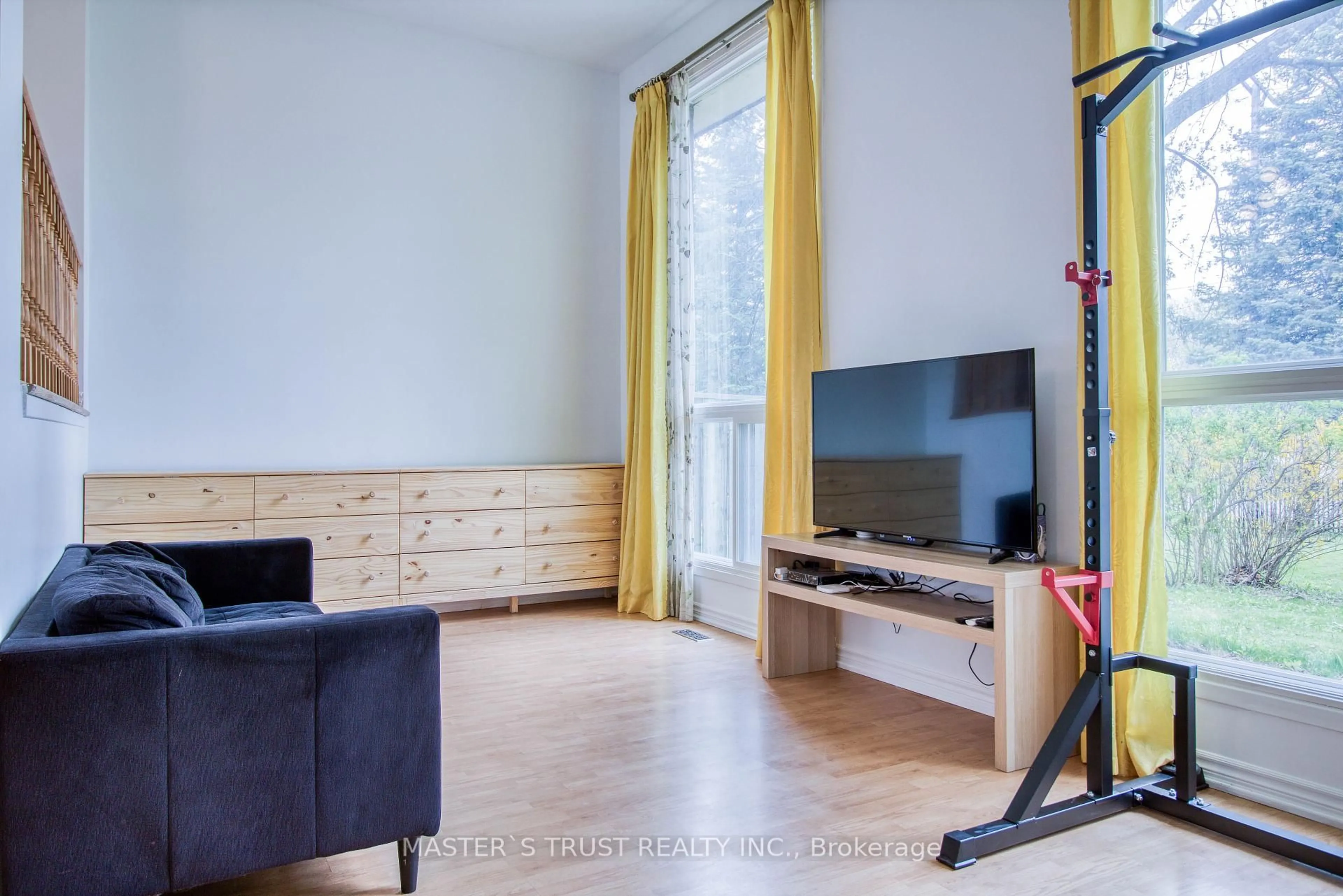 Living room with furniture, wood/laminate floor for 129 Huntingdale Blvd, Toronto Ontario M1W 1T2
