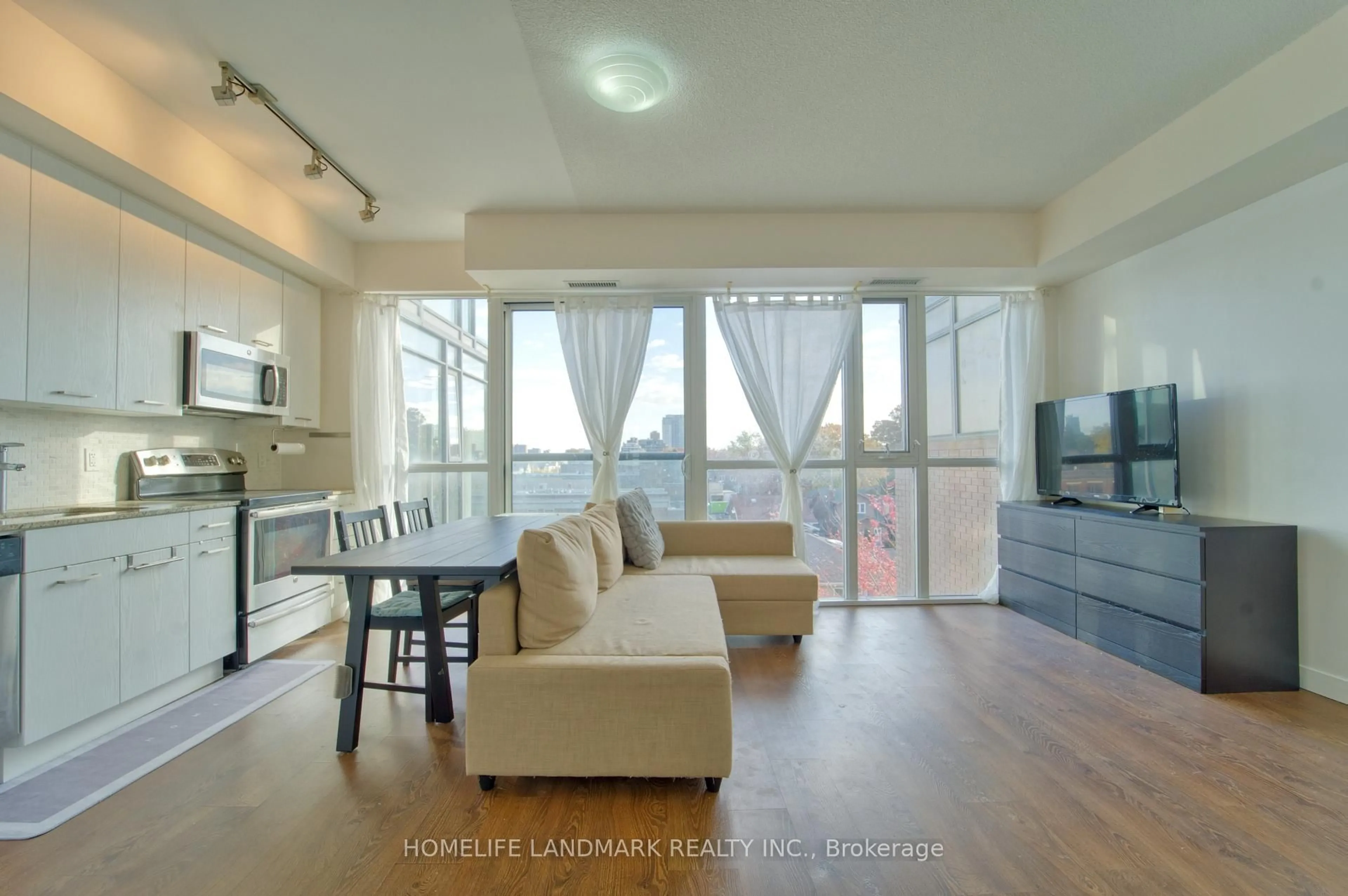 Living room with furniture, wood/laminate floor for 2055 Danforth Ave #509, Toronto Ontario M4C 1J8