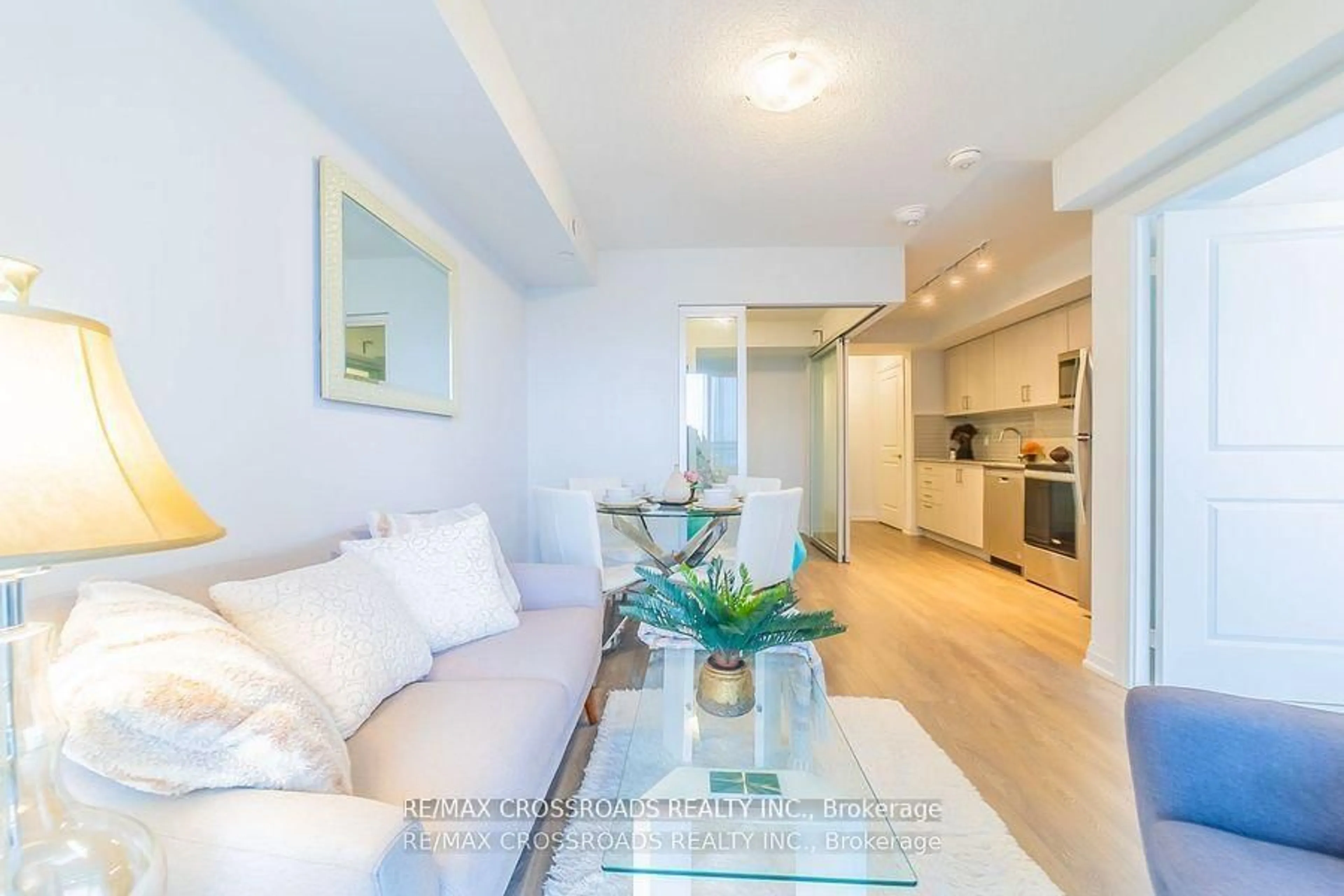 Living room with furniture, wood/laminate floor for 20 Meadowglen Pl #422, Toronto Ontario M1G 0A9