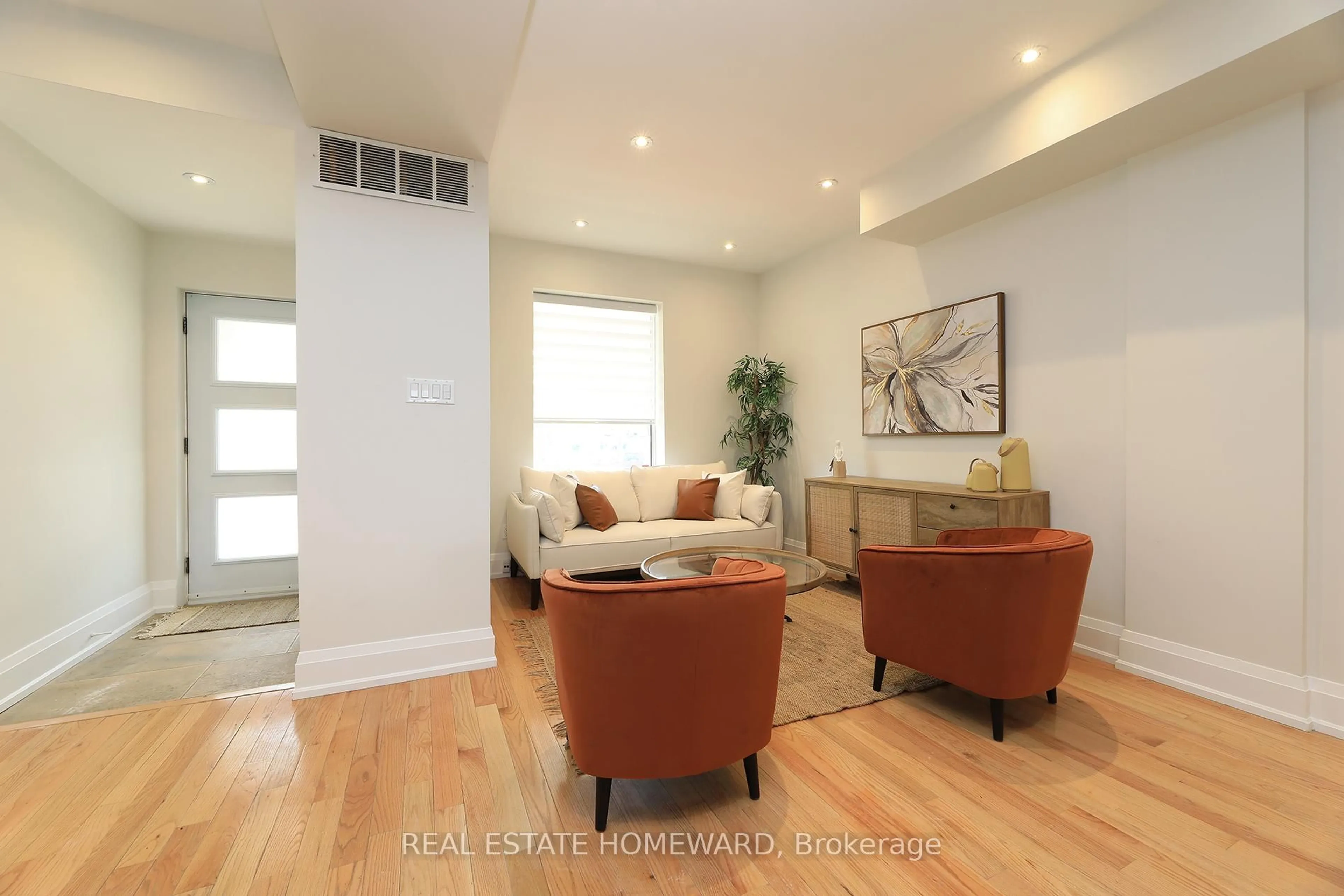 Living room with furniture, wood/laminate floor for 38 & 40 Cedarvale Ave, Toronto Ontario M4C 4J4