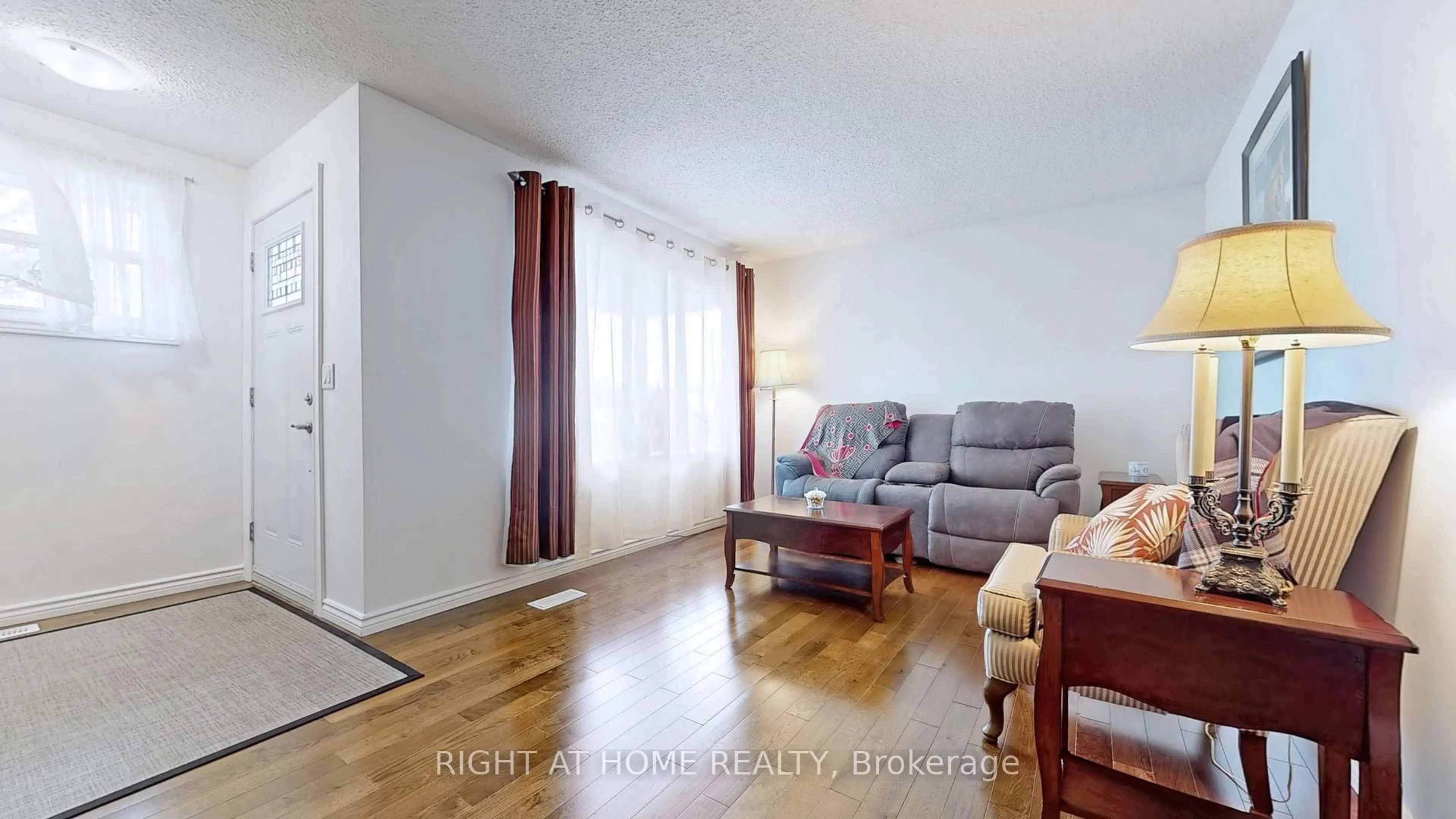 Living room with furniture, wood/laminate floor for 766 Kenora Ave, Oshawa Ontario L1J 1K6