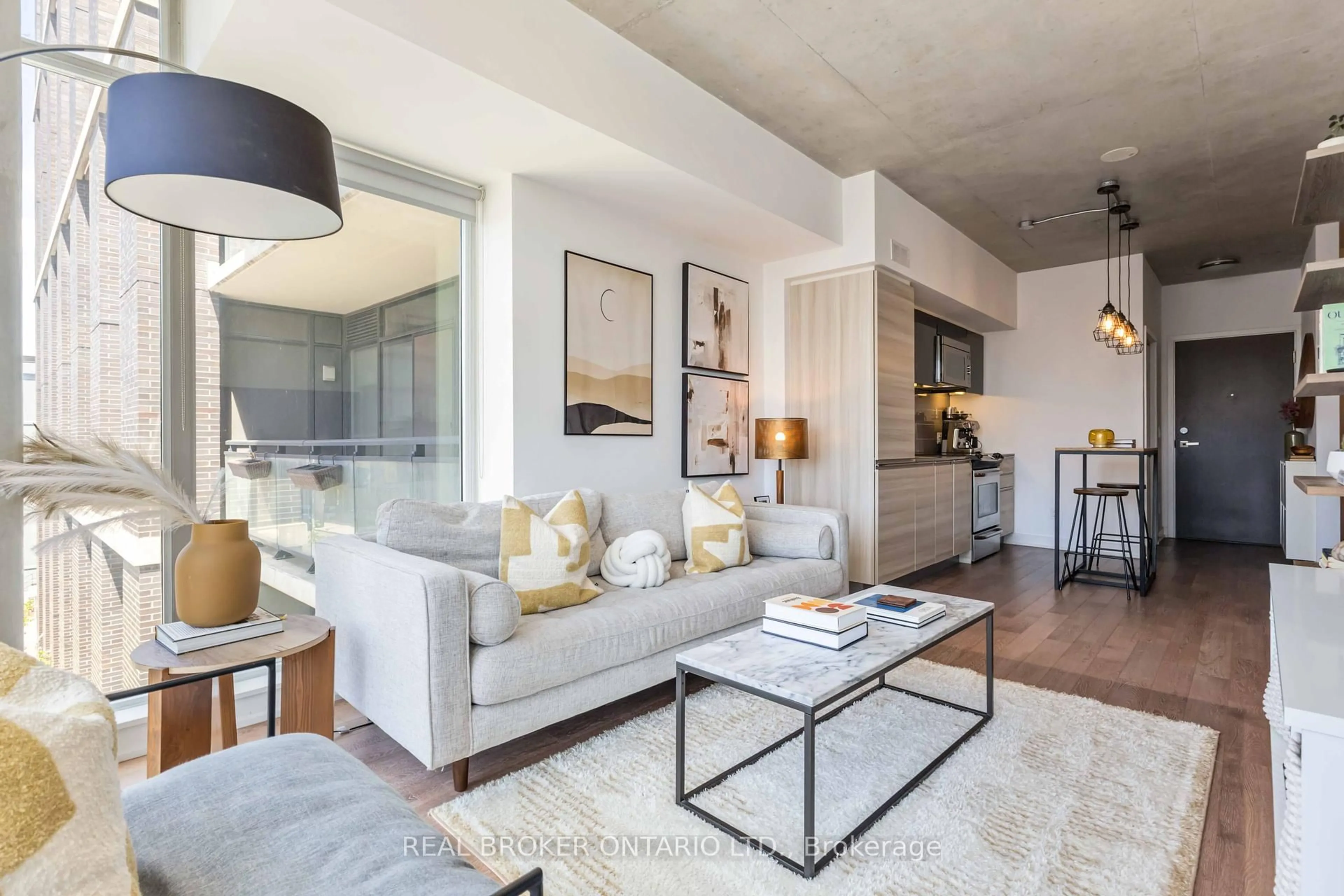 Living room with furniture, cement floor for 1190 Dundas St #318, Toronto Ontario M4M 0C5