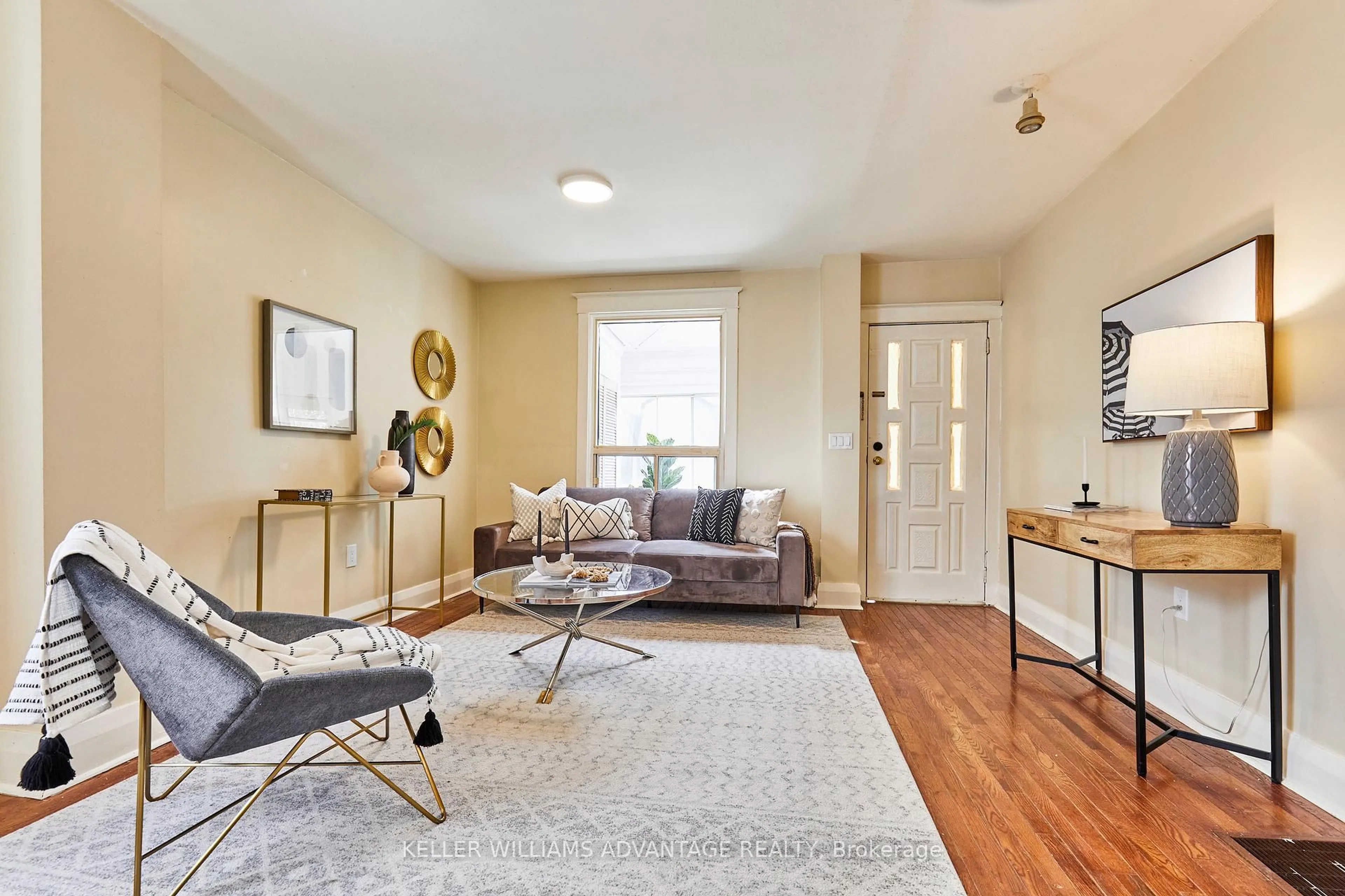 Living room with furniture, wood/laminate floor for 808 Sammon Ave, Toronto Ontario M4C 2E8