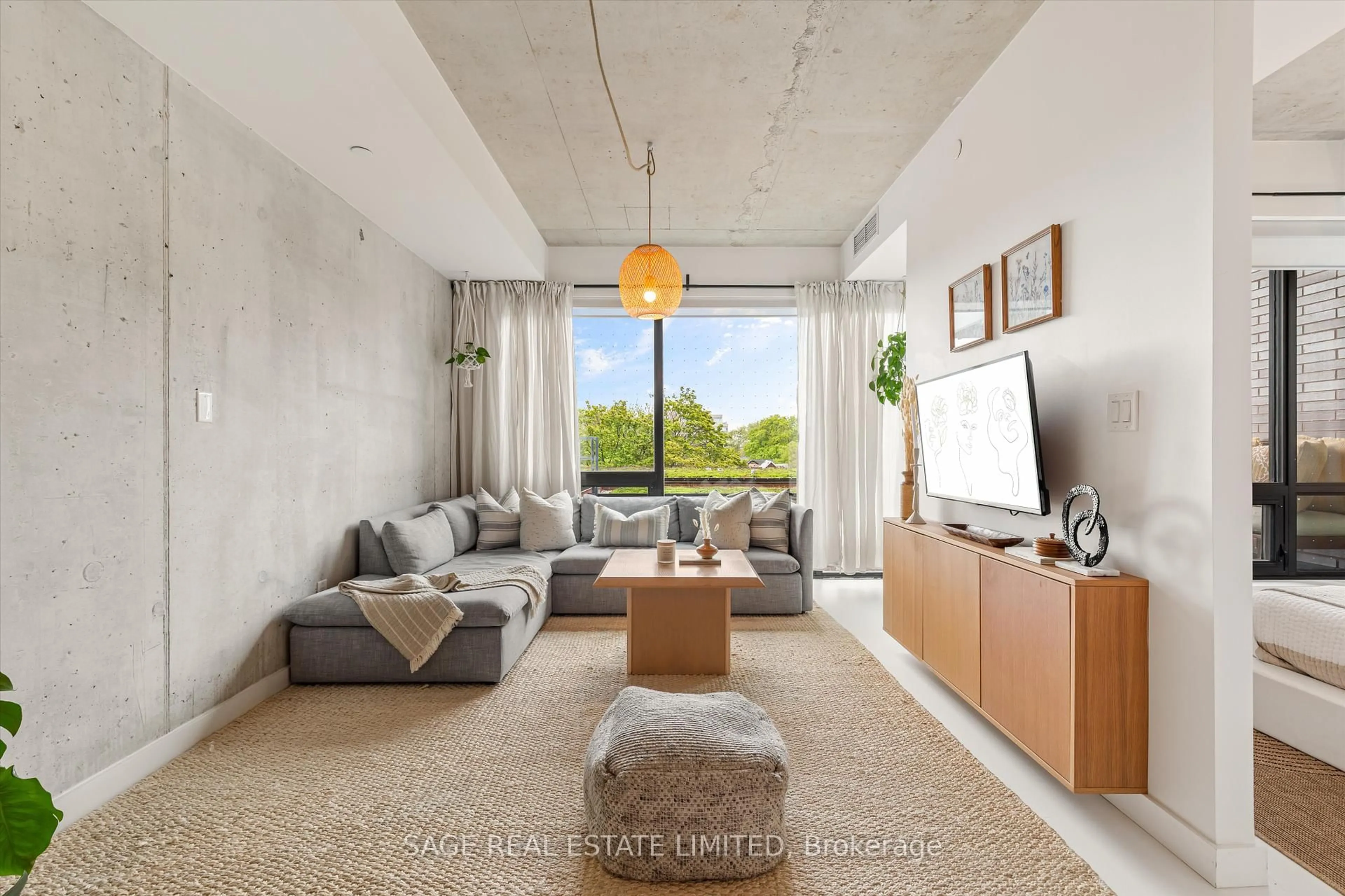 Living room with furniture, cement floor for 246 Logan Ave #406, Toronto Ontario M4M 0E9