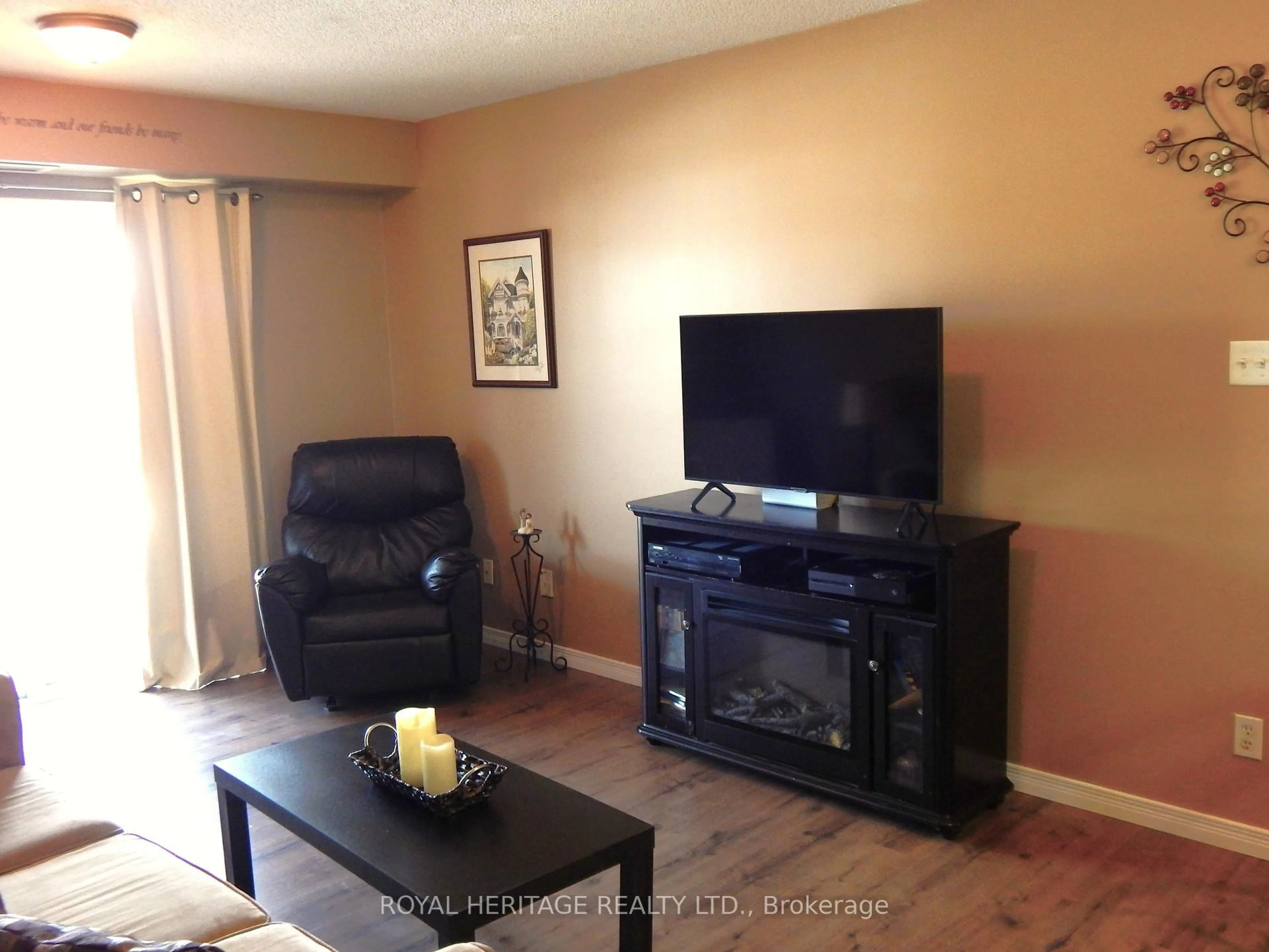 Living room with furniture, wood/laminate floor for 132 Aspen Springs Dr #307, Clarington Ontario L1C 0H1