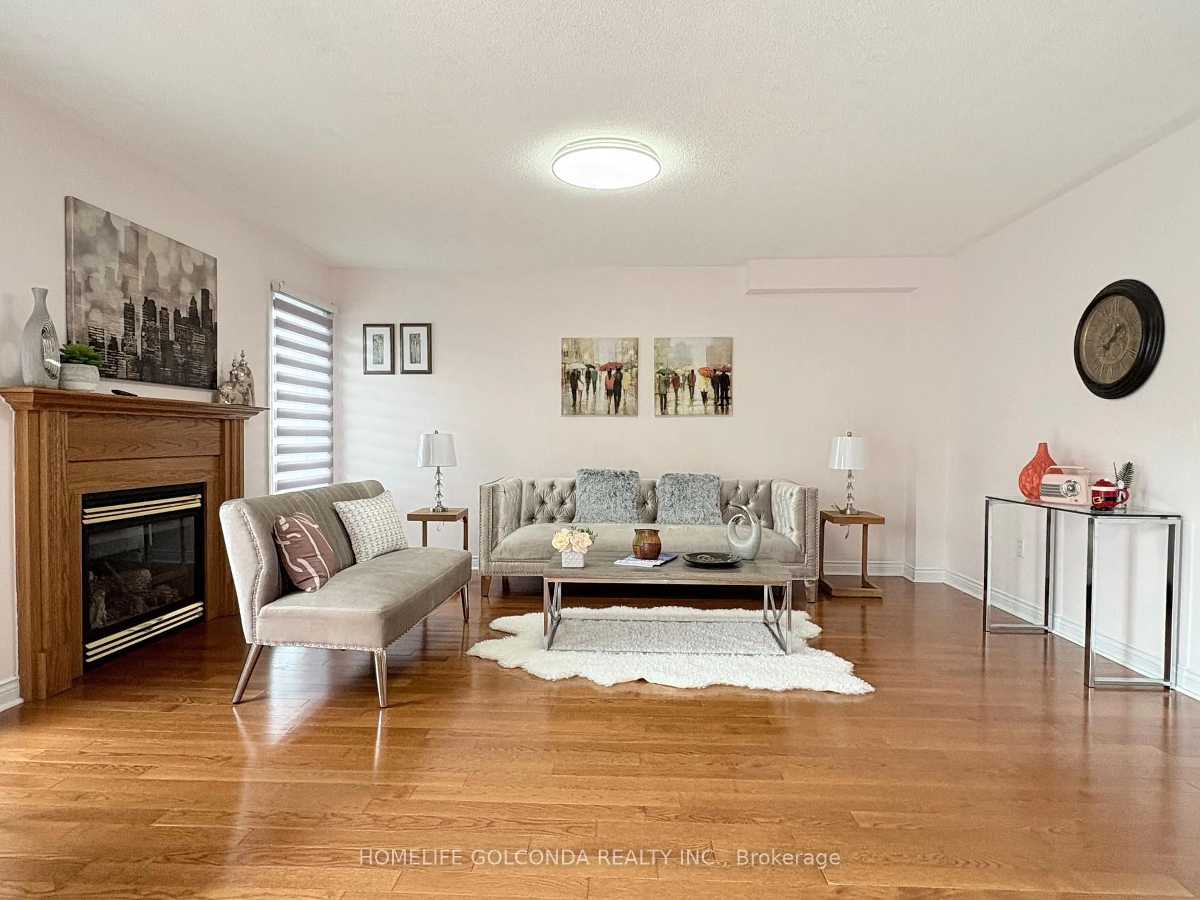 Living room with furniture, wood/laminate floor for 56 Lurosa Cres, Whitby Ontario L1R 3A9