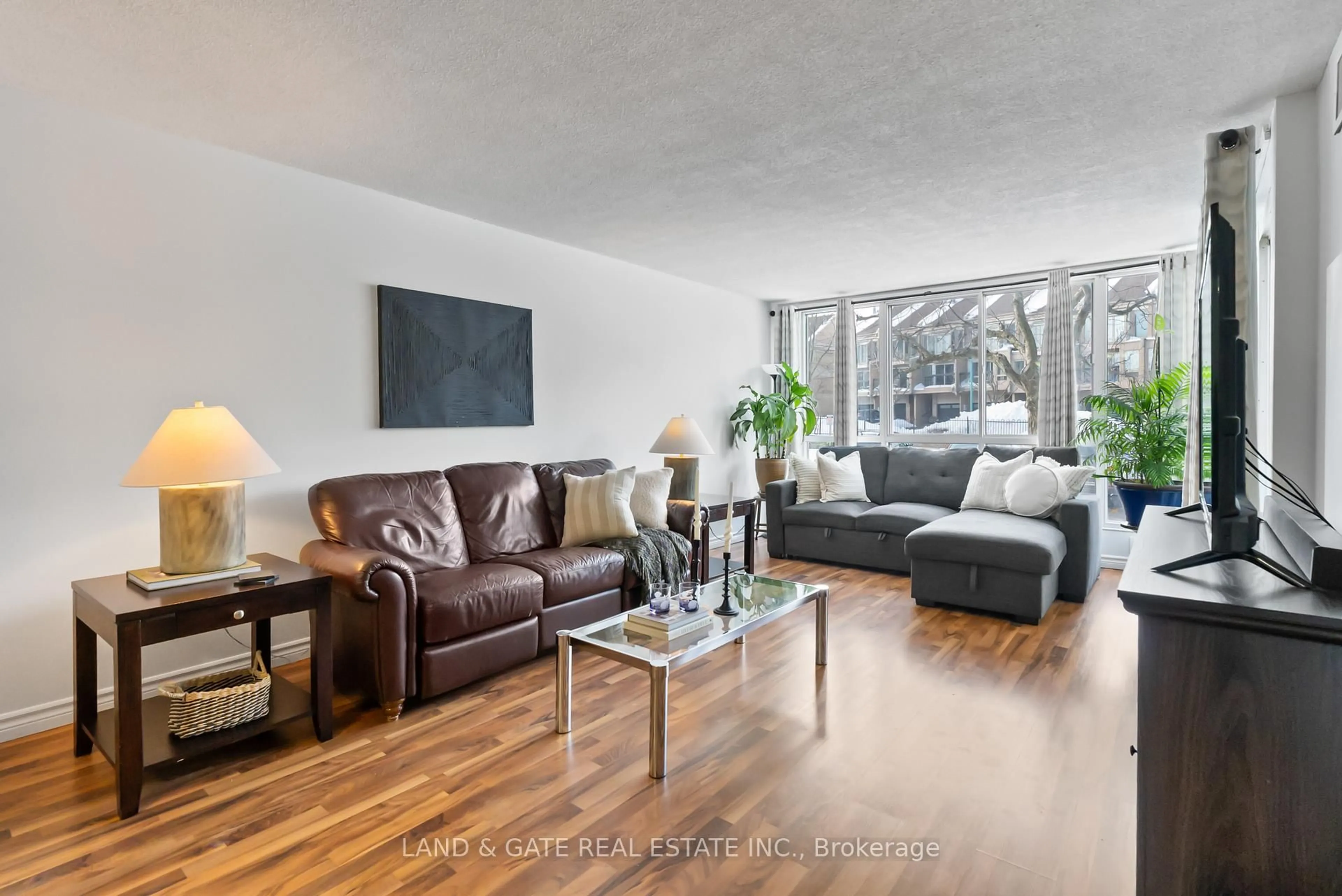 Living room with furniture, wood/laminate floor for 25 Cumberland Lane #112, Ajax Ontario L1S 7K1