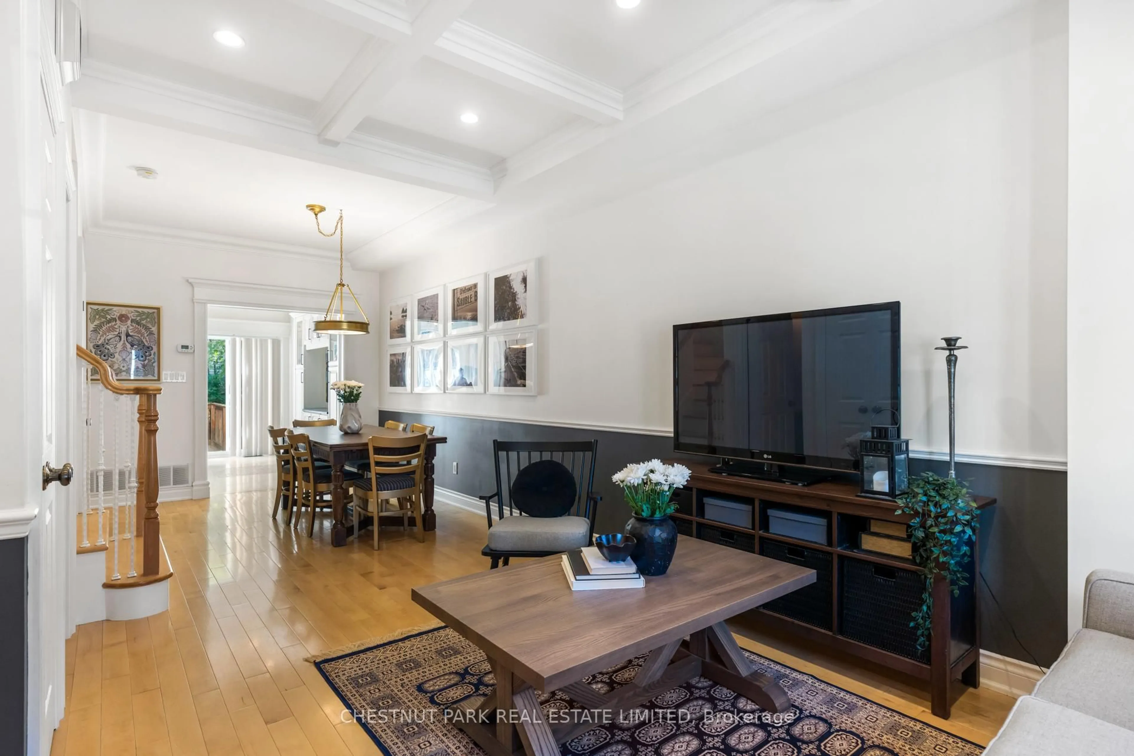 Living room with furniture, wood/laminate floor for 129 Jones Ave, Toronto Ontario M4M 2Z7