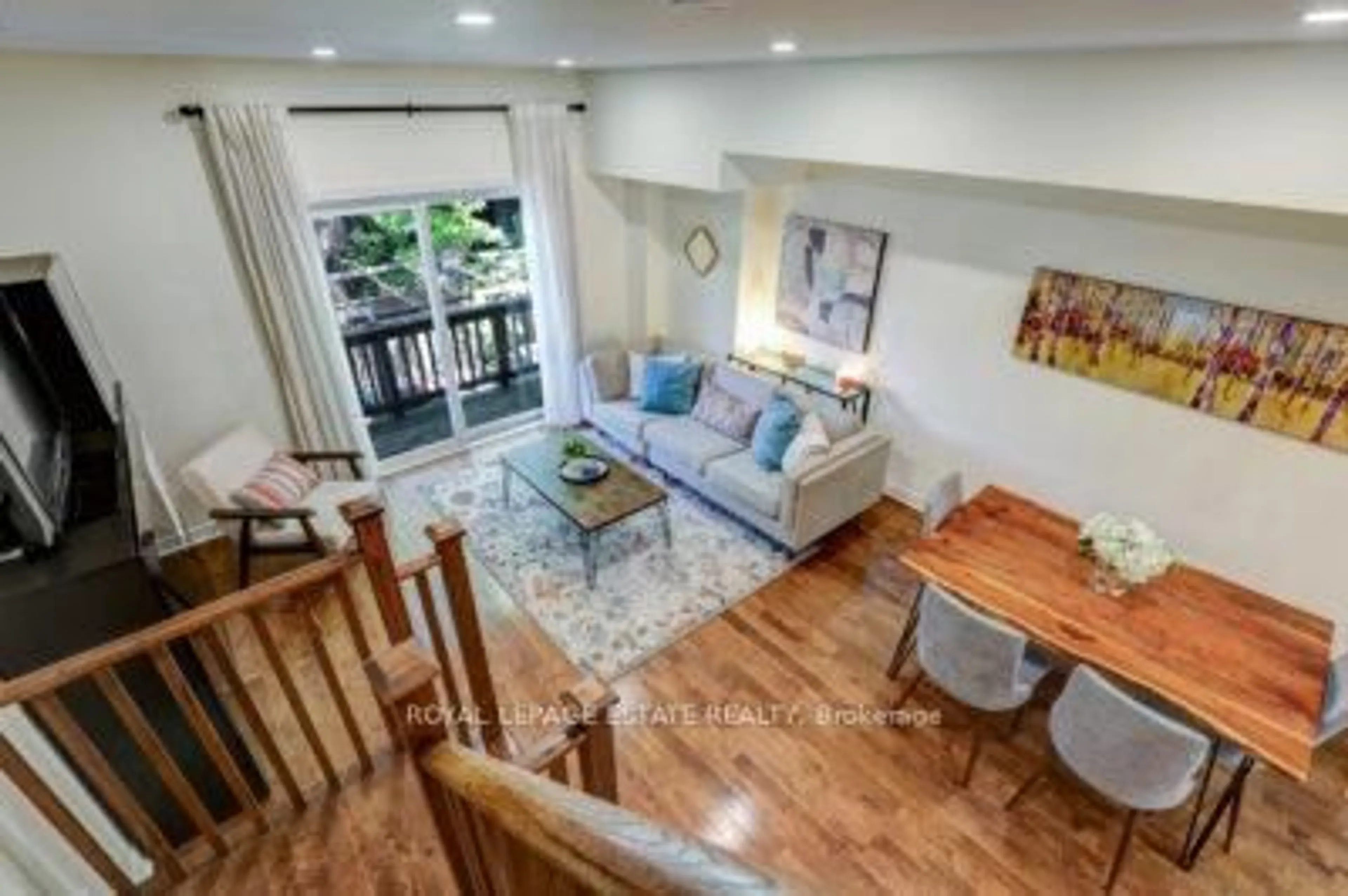 Living room with furniture, wood/laminate floor for 23 Hodge Lane, Toronto Ontario M4E 3Y3