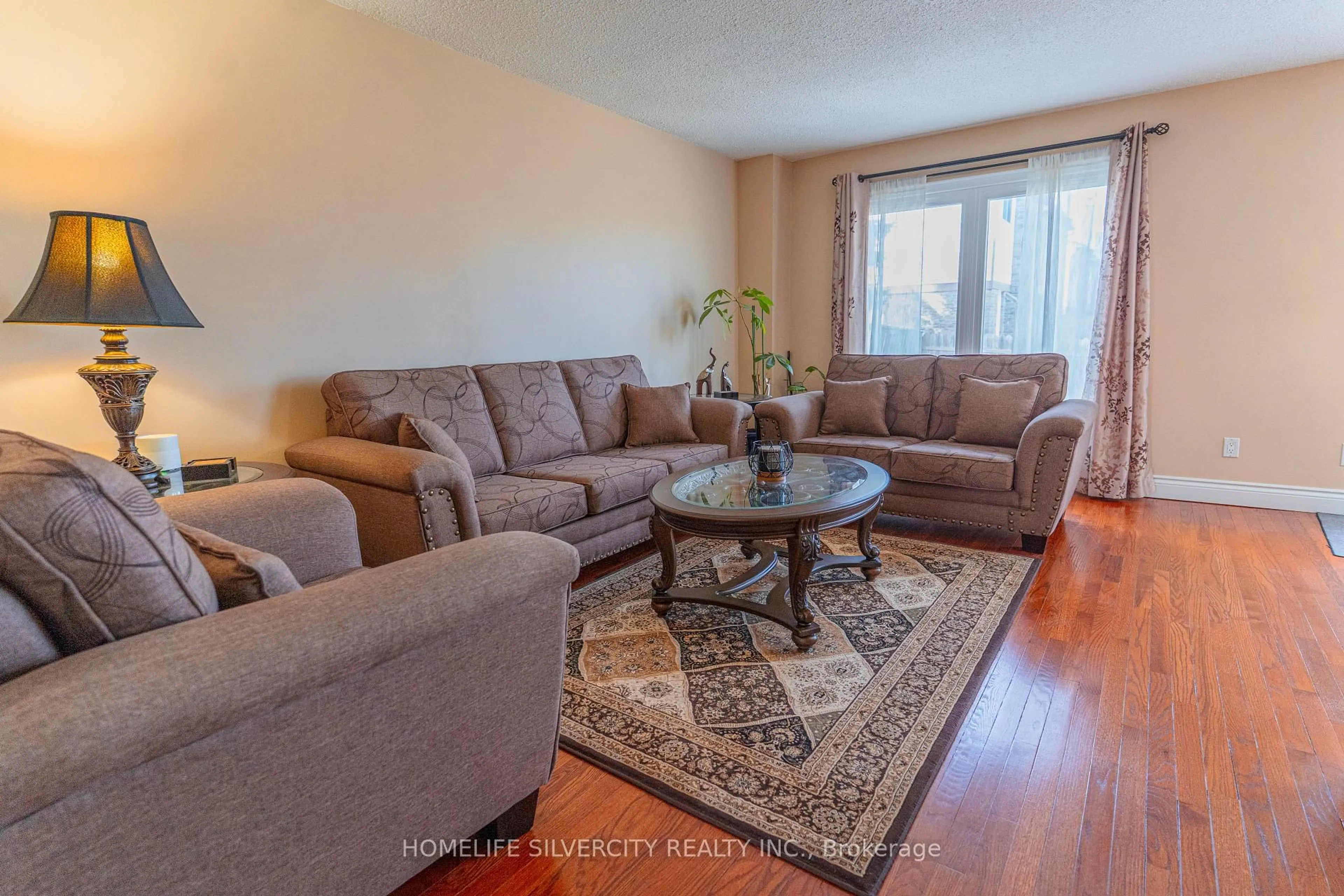 Living room with furniture, wood/laminate floor for 79 Green Springs Dr, Toronto Ontario M1V 2A9