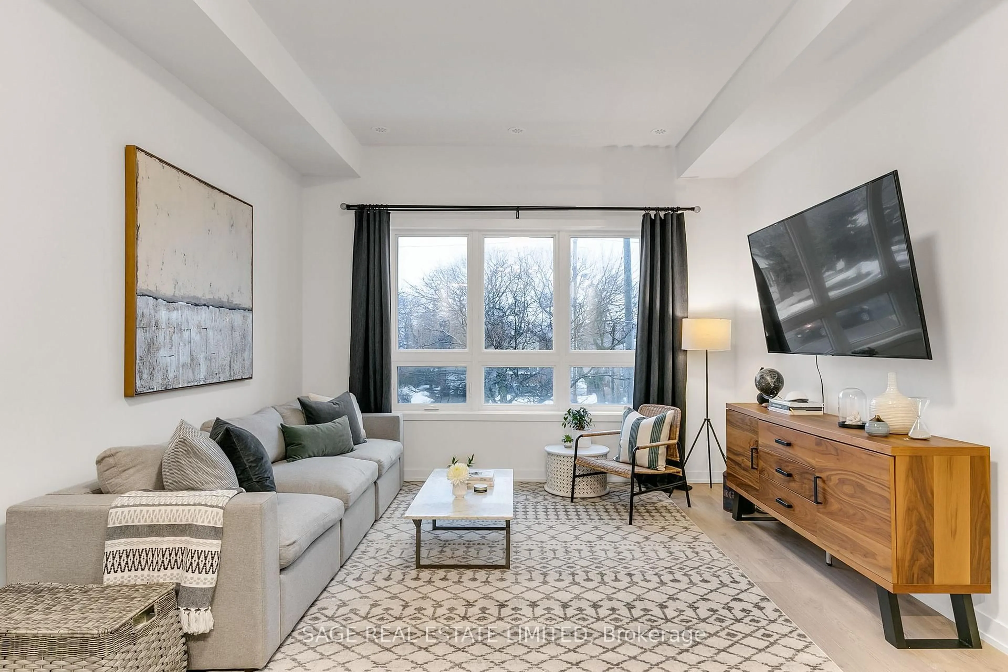 Living room with furniture, carpet floor for 3686 St Clair Ave #103, Toronto Ontario M1M 0E4