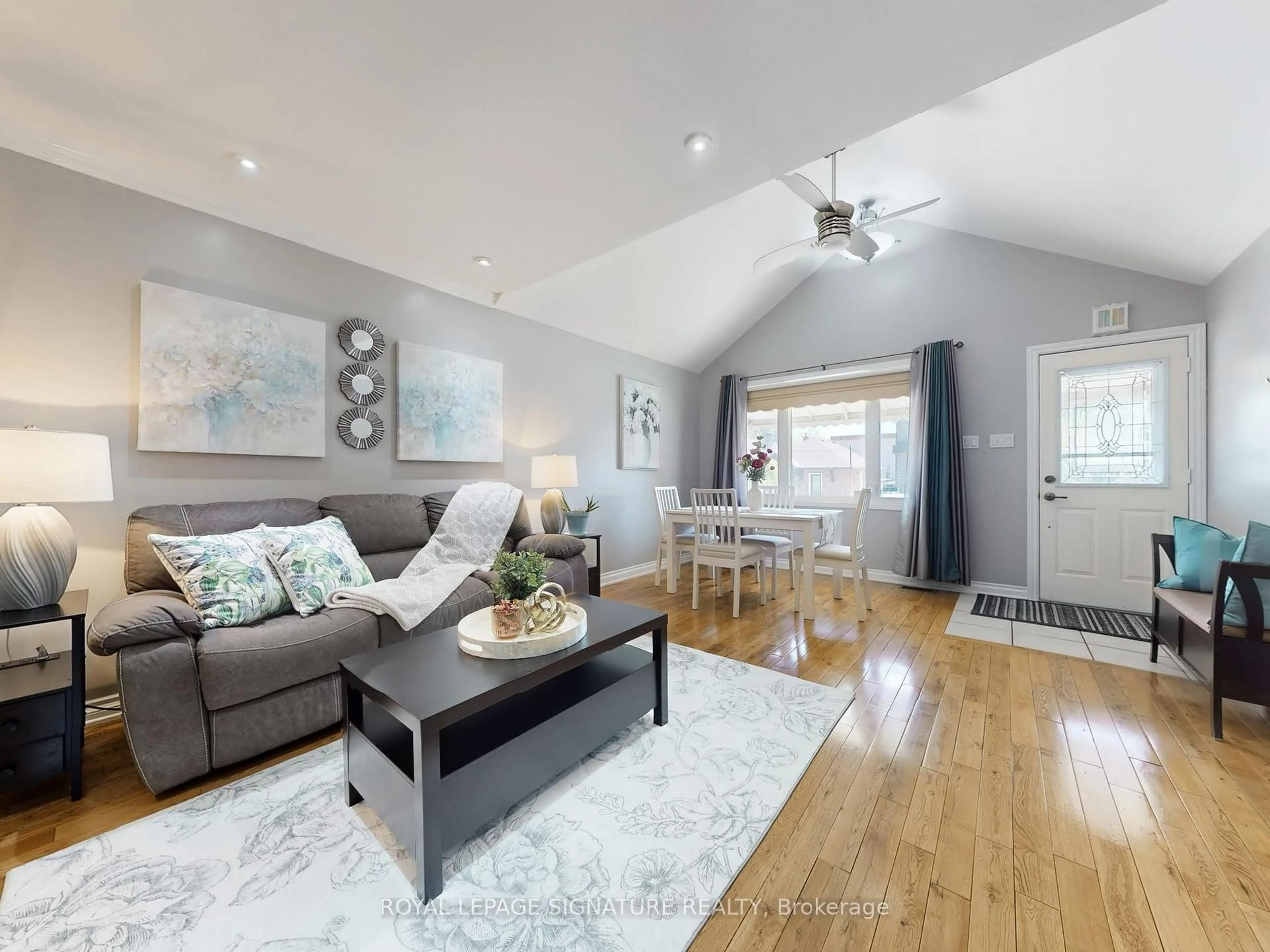 Living room with furniture, wood/laminate floor for 261 Glebemount Ave, Toronto Ontario M4C 3T7