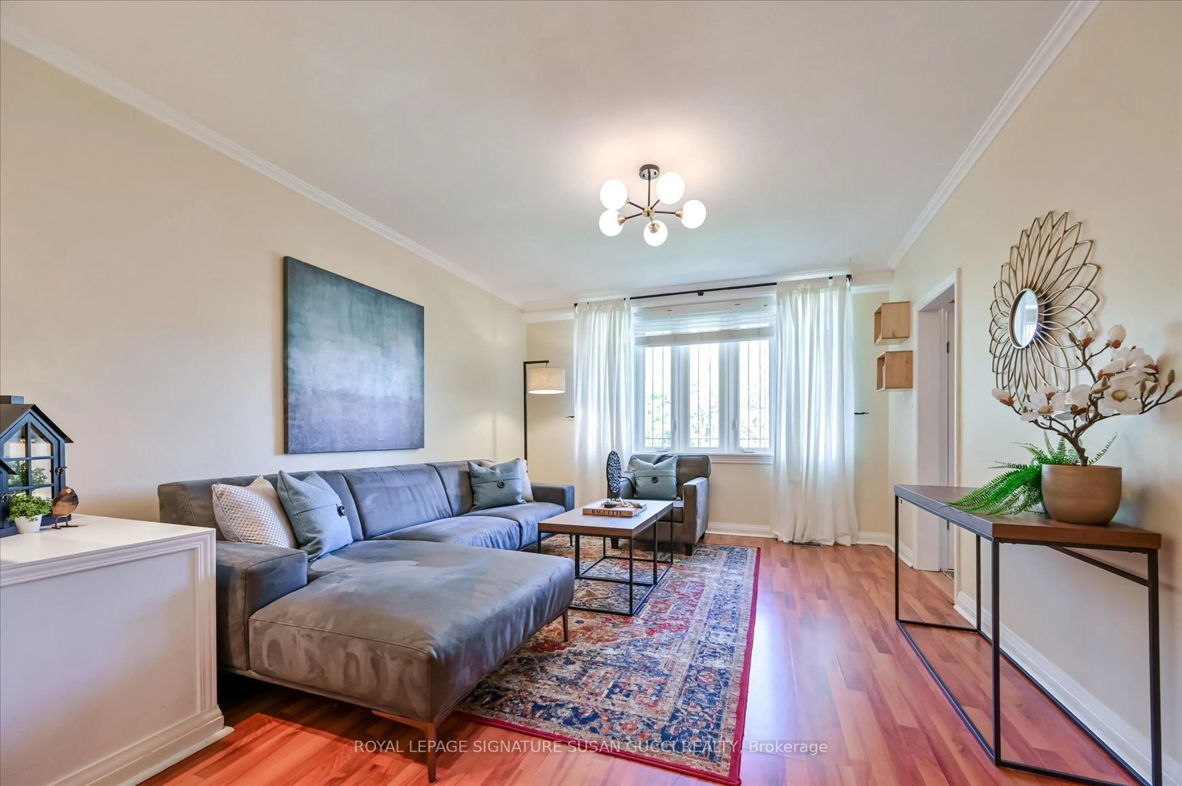 Living room with furniture, wood/laminate floor for 1006 Victoria Park Ave, Toronto Ontario M4B 2J6