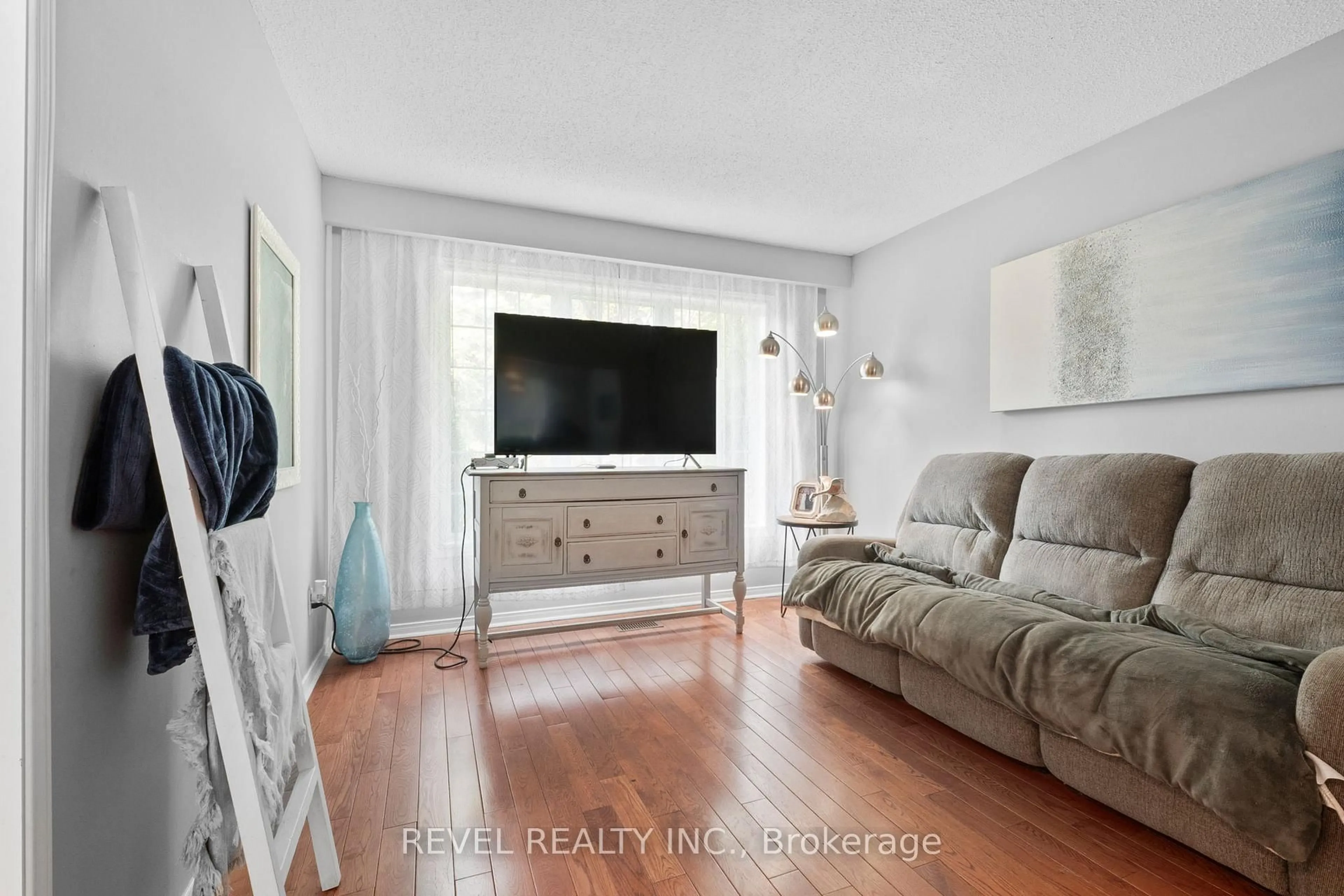 Living room with furniture, wood/laminate floor for 12 Robinson Cres, Whitby Ontario L1N 6W5
