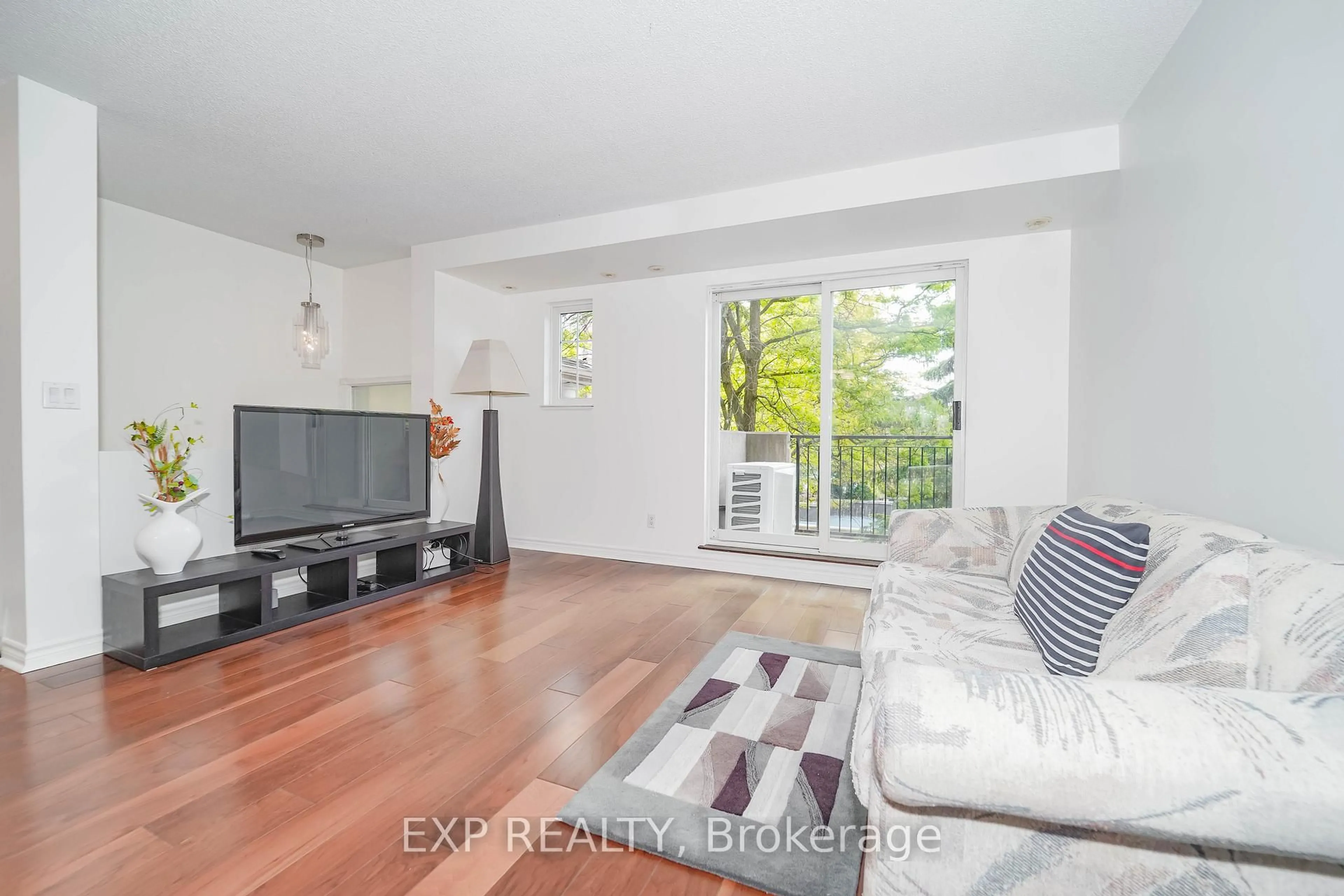 Living room with furniture, wood/laminate floor for 1881 Mcnicoll Ave #558, Toronto Ontario M1V 5M2