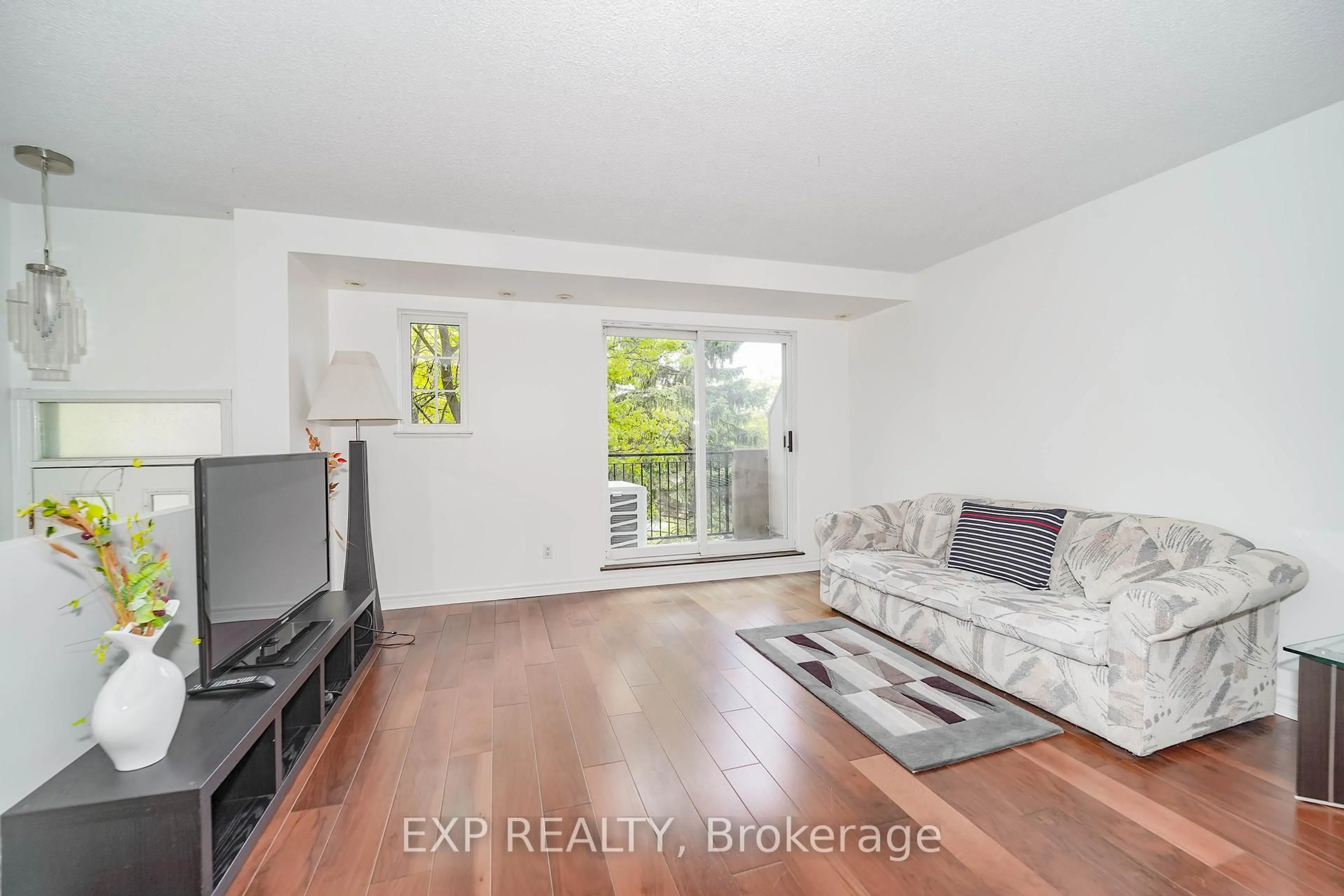 Living room with furniture, wood/laminate floor for 1881 Mcnicoll Ave #558, Toronto Ontario M1V 5M2