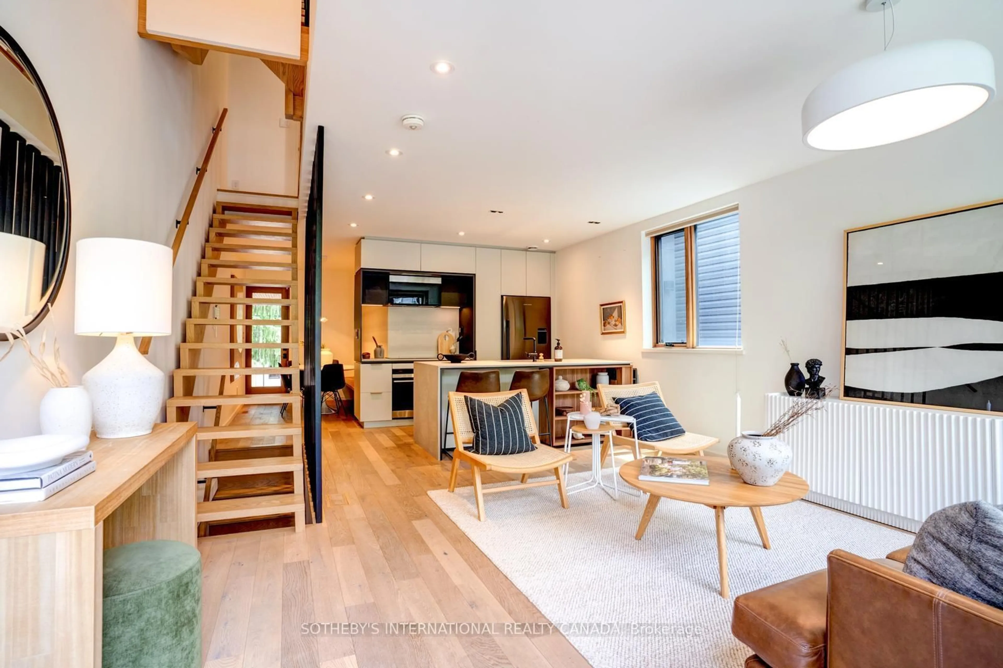 Living room with furniture, wood/laminate floor for 79 Eaton Ave #1, Toronto Ontario M4J 2Z4