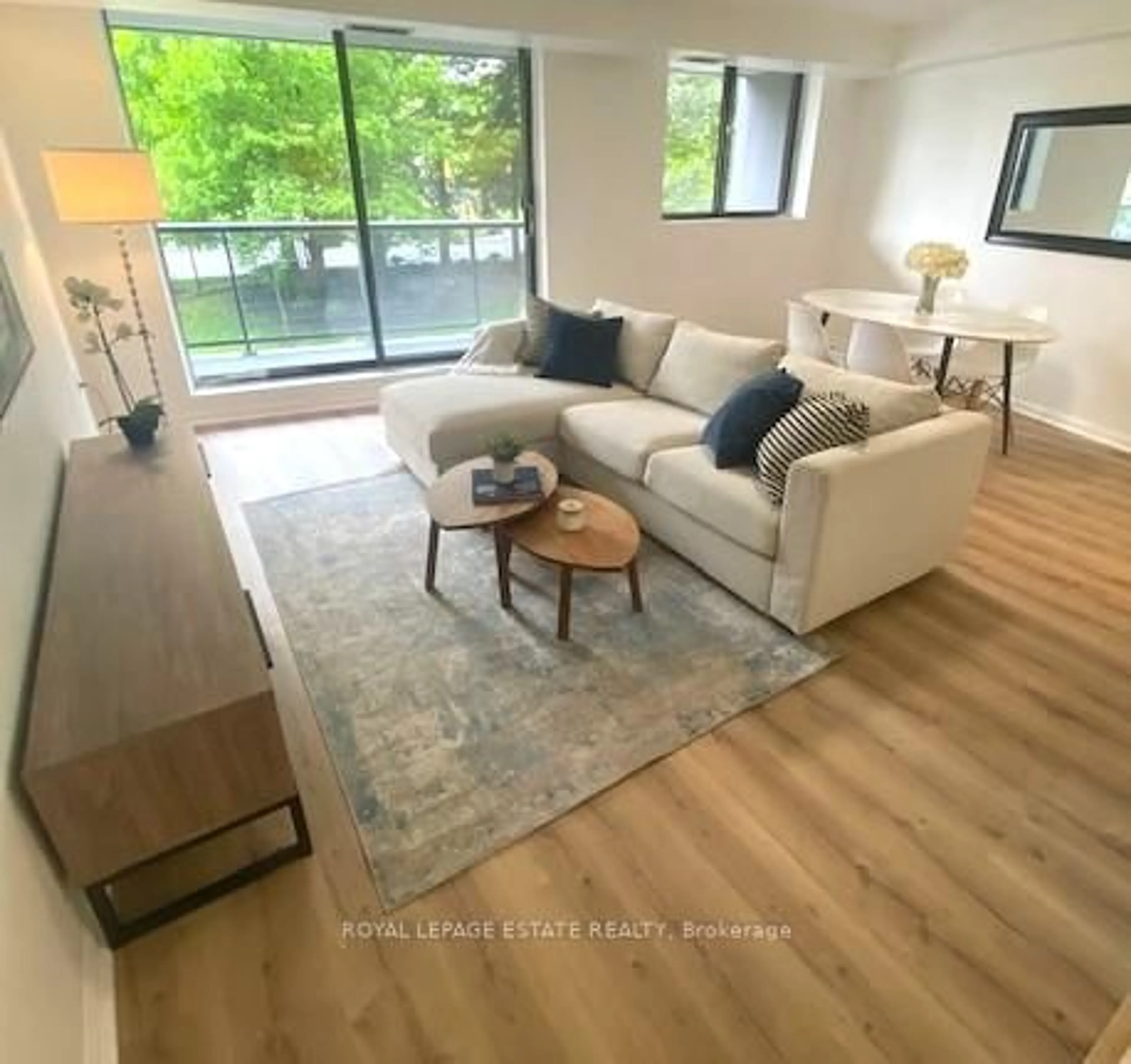 Living room with furniture, wood/laminate floor for 757 Victoria Park Ave #201, Toronto Ontario M4C 5N8