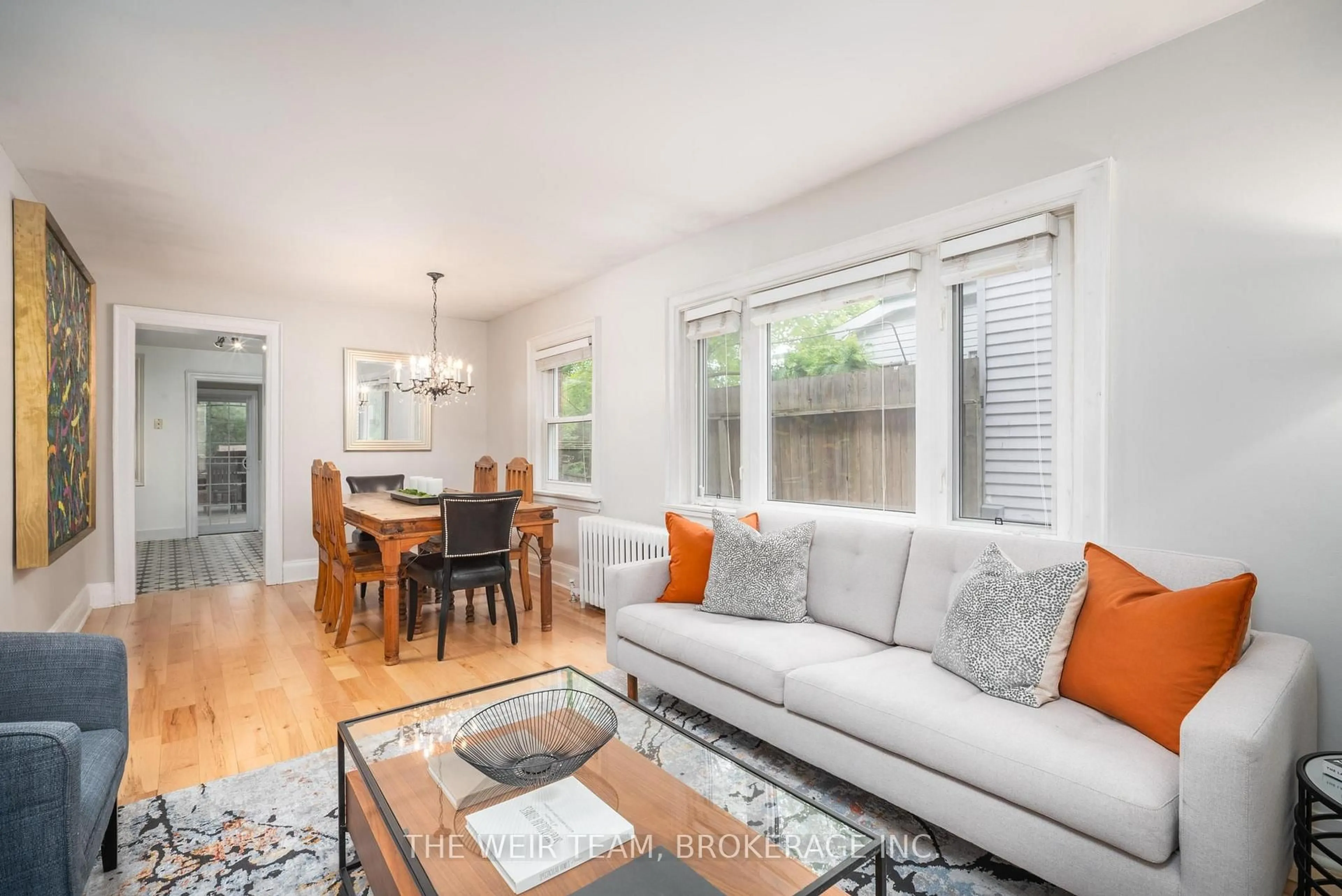 Living room with furniture, wood/laminate floor for 39 Ashland Ave, Toronto Ontario M4L 1J9