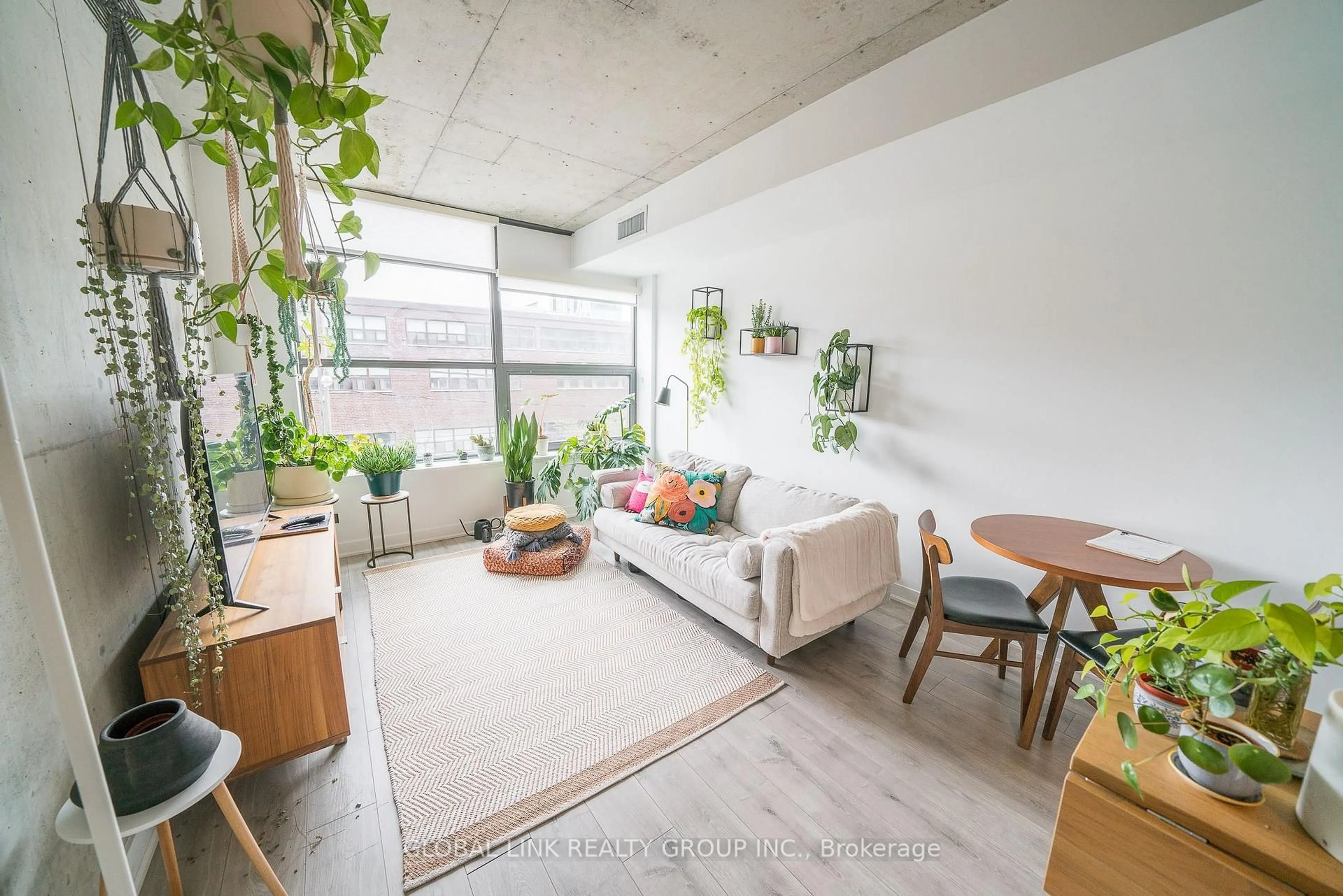 Living room with furniture, cement floor for 319 Carlaw Ave #306, Toronto Ontario M4M 0A4