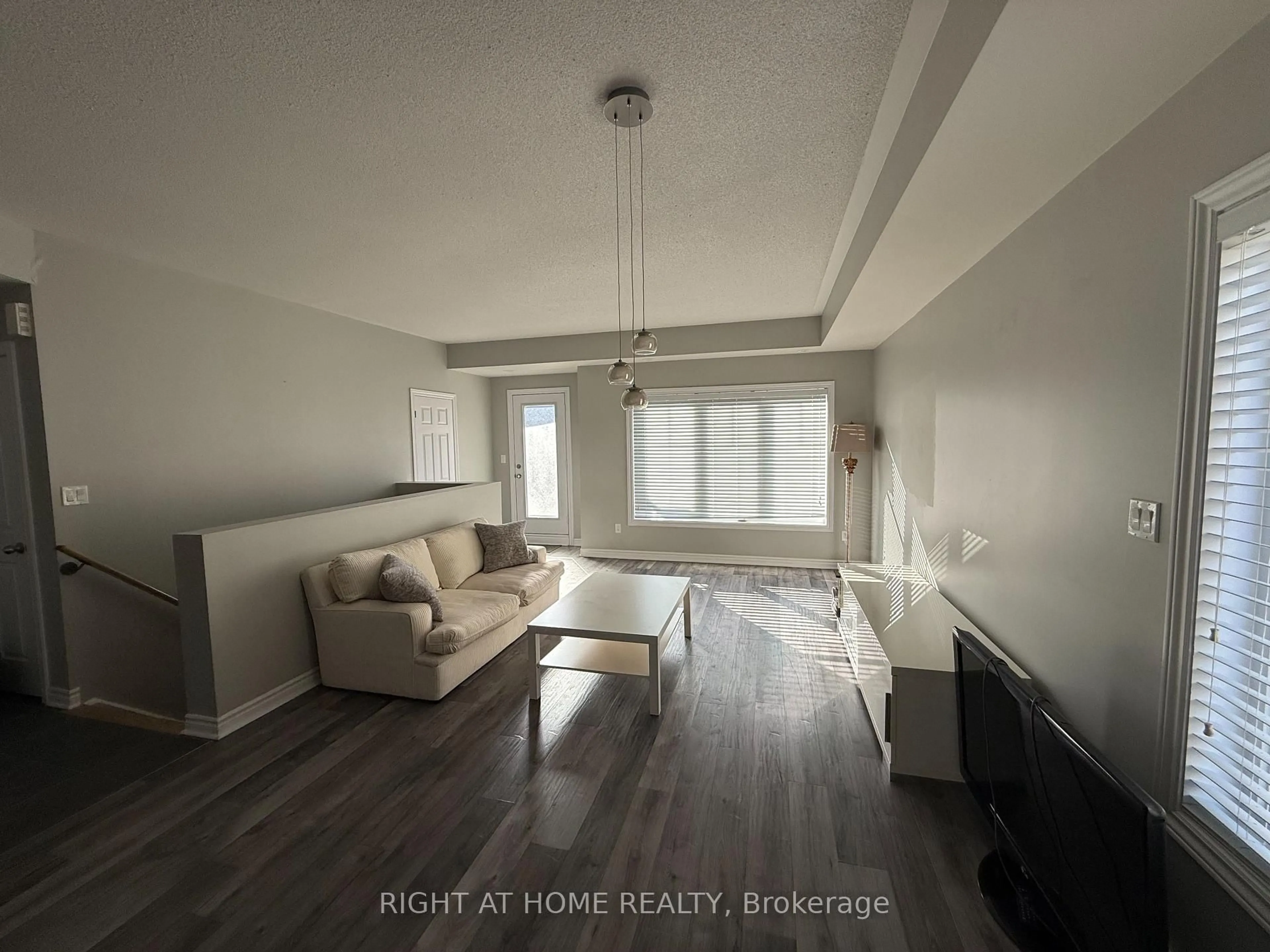 Living room with furniture, wood/laminate floor for 11 Eaton Park Lane #3, Toronto Ontario M1W 0A5