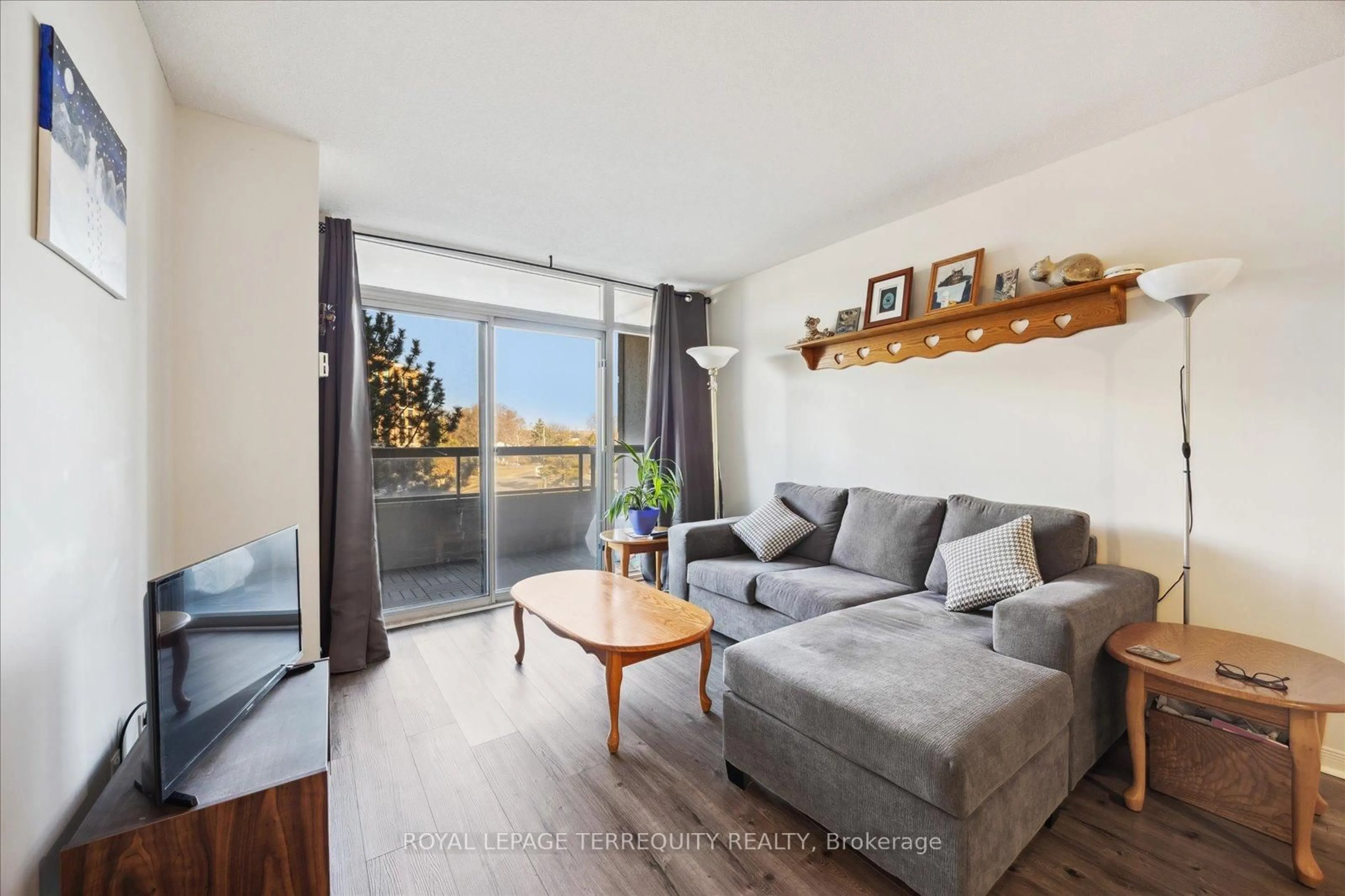 Living room with furniture, wood/laminate floor for 1000 The Esplanade #316, Pickering Ontario L1V 6V4