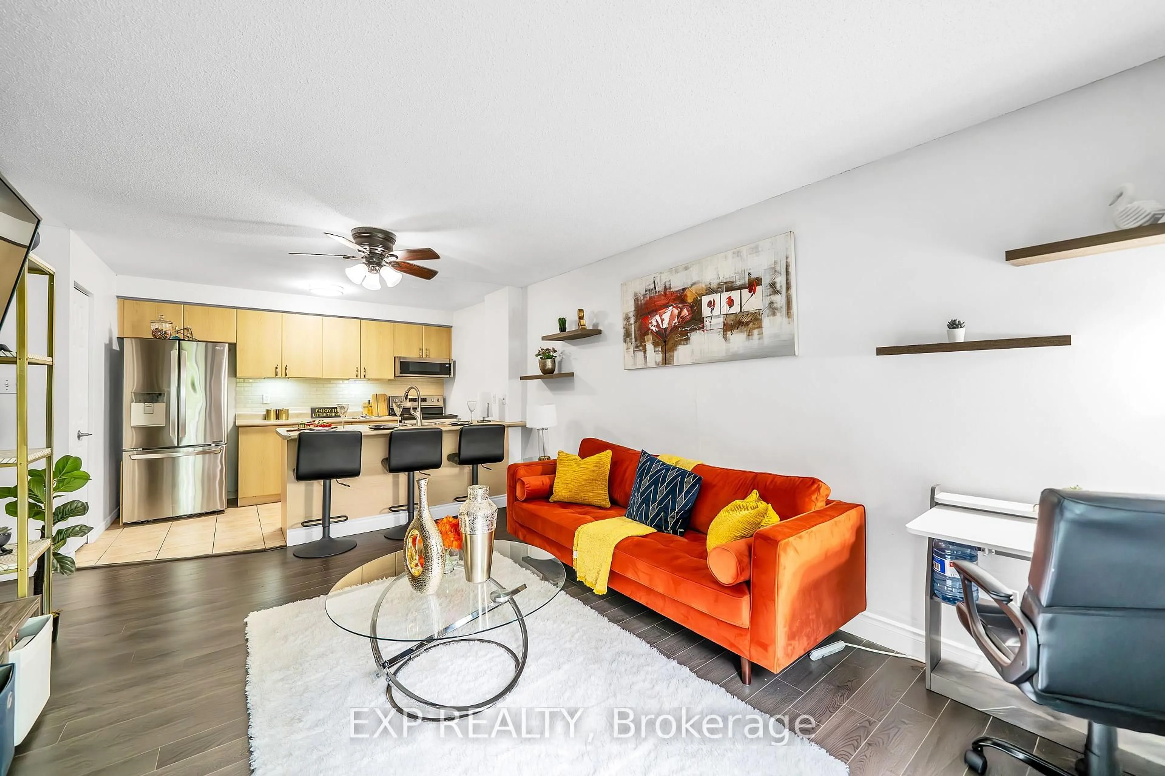 Living room with furniture, wood/laminate floor for 83 Aspen Springs Dr #208, Clarington Ontario L1C 5J7