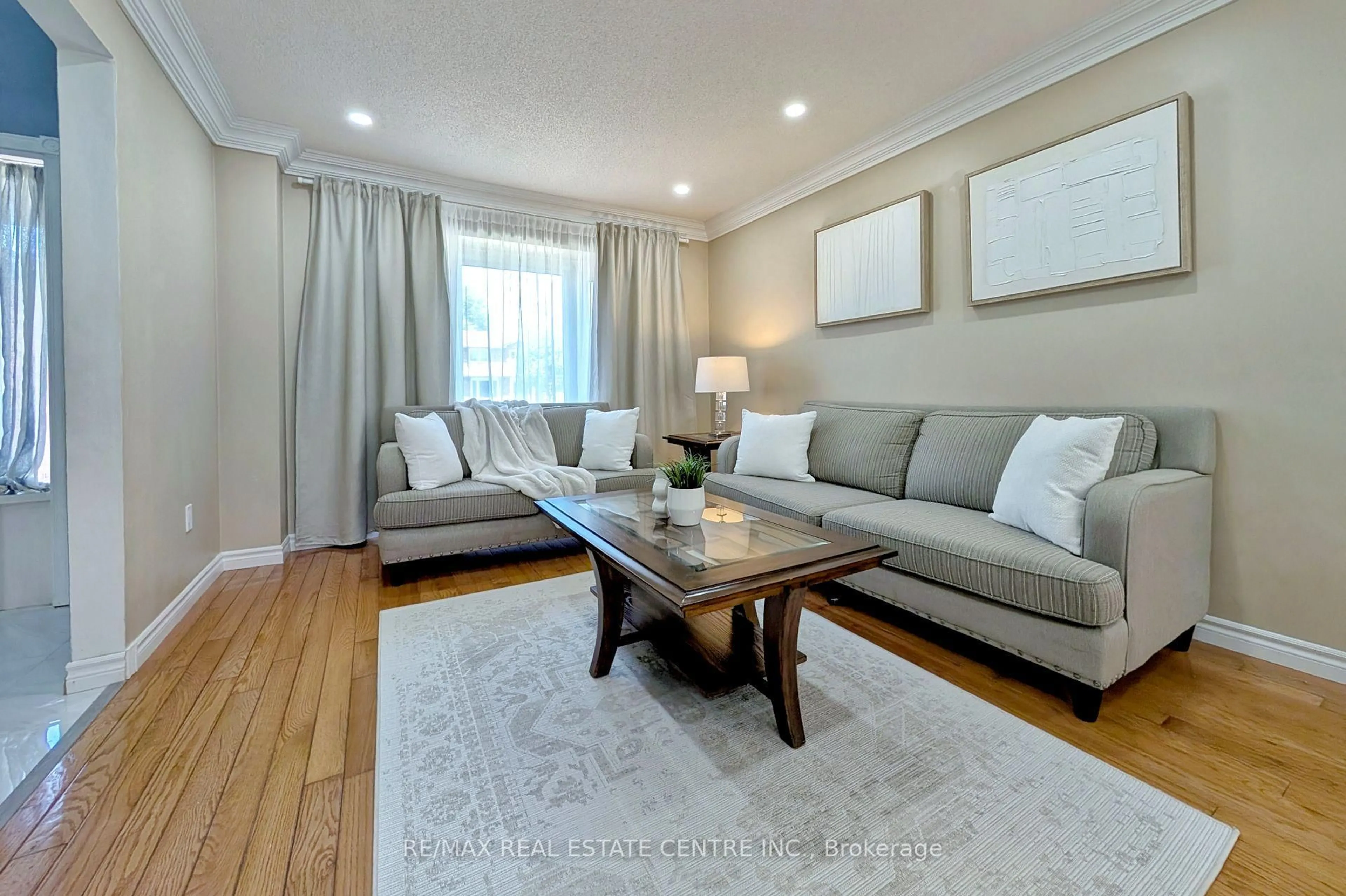 Living room with furniture, wood/laminate floor for 105 Rollo Dr, Ajax Ontario L1S 7B8