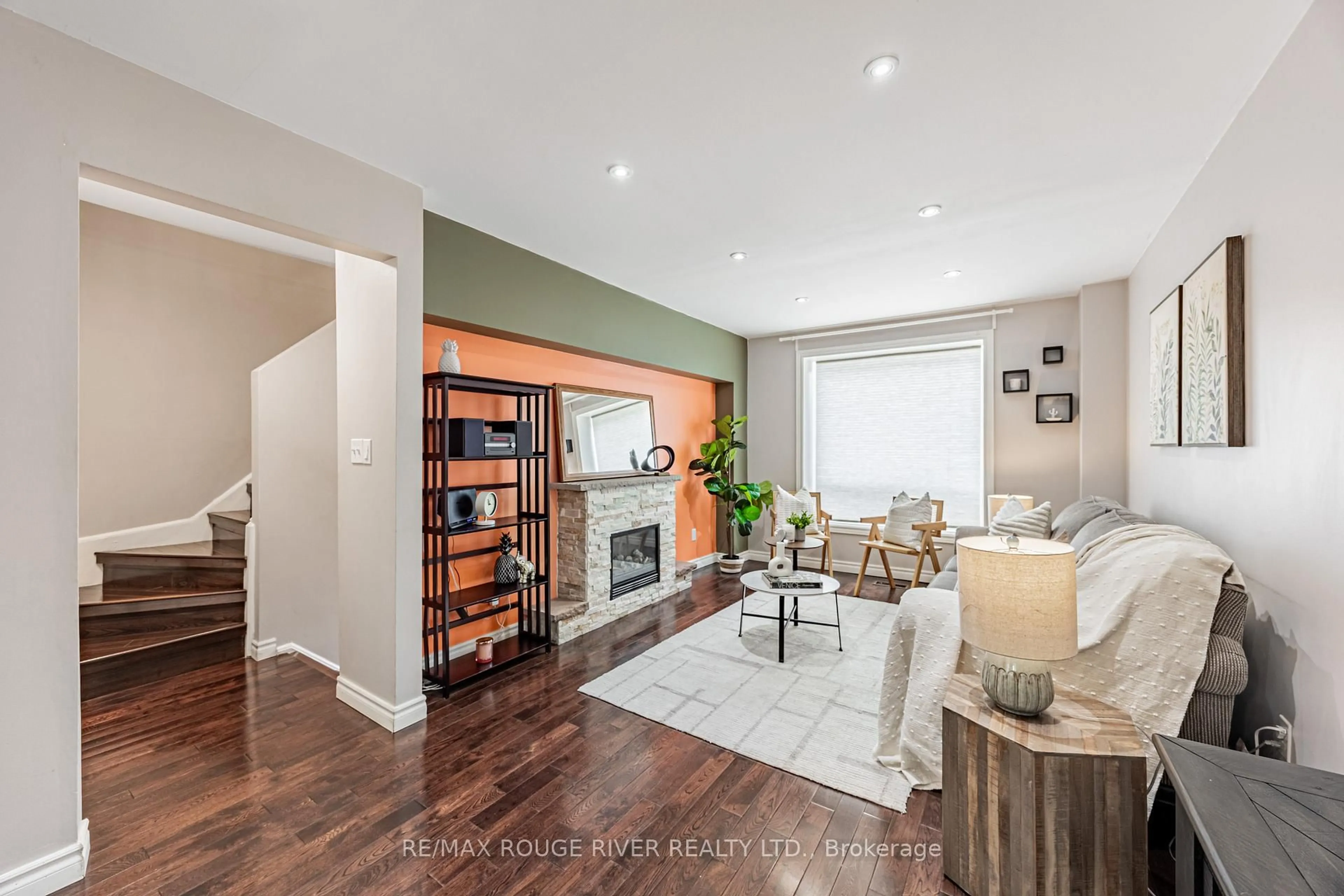 Living room with furniture, wood/laminate floor for 55 Collinsgrove Rd #214, Toronto Ontario M1E 4Z2