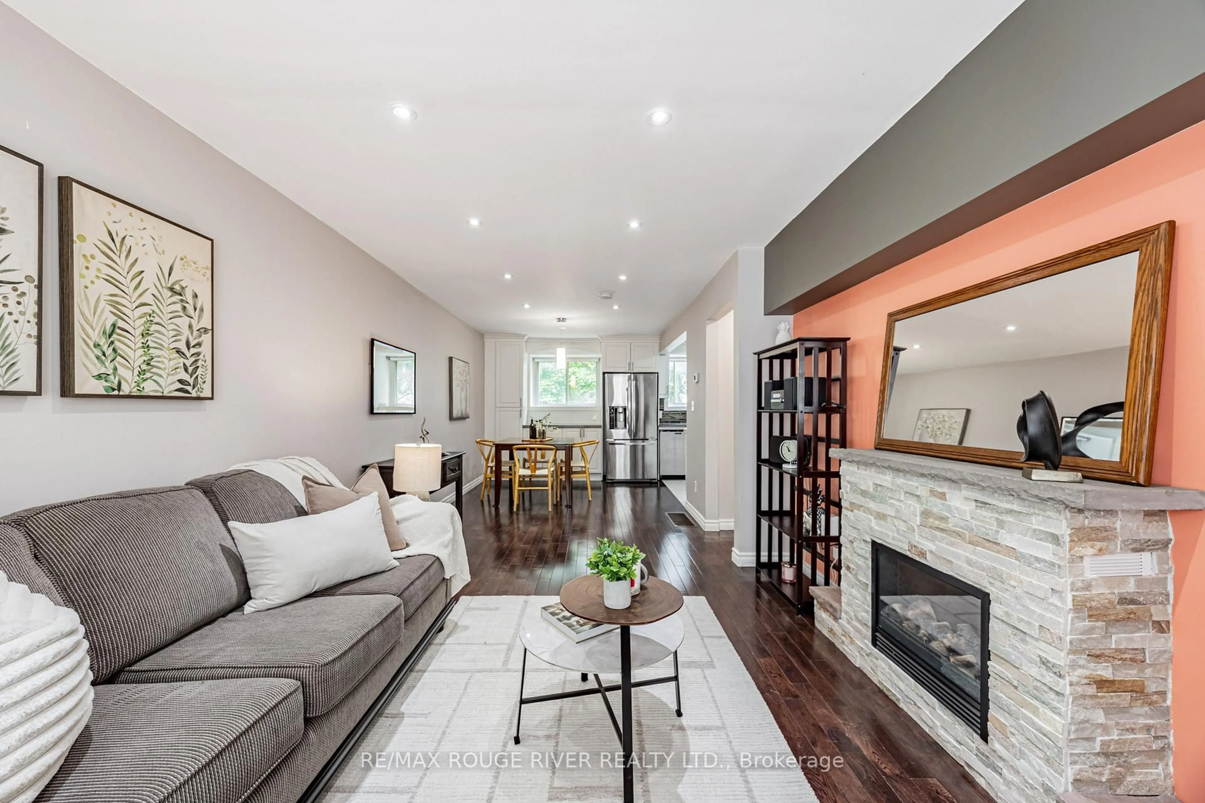 Living room with furniture, wood/laminate floor for 55 Collinsgrove Rd #214, Toronto Ontario M1E 4Z2