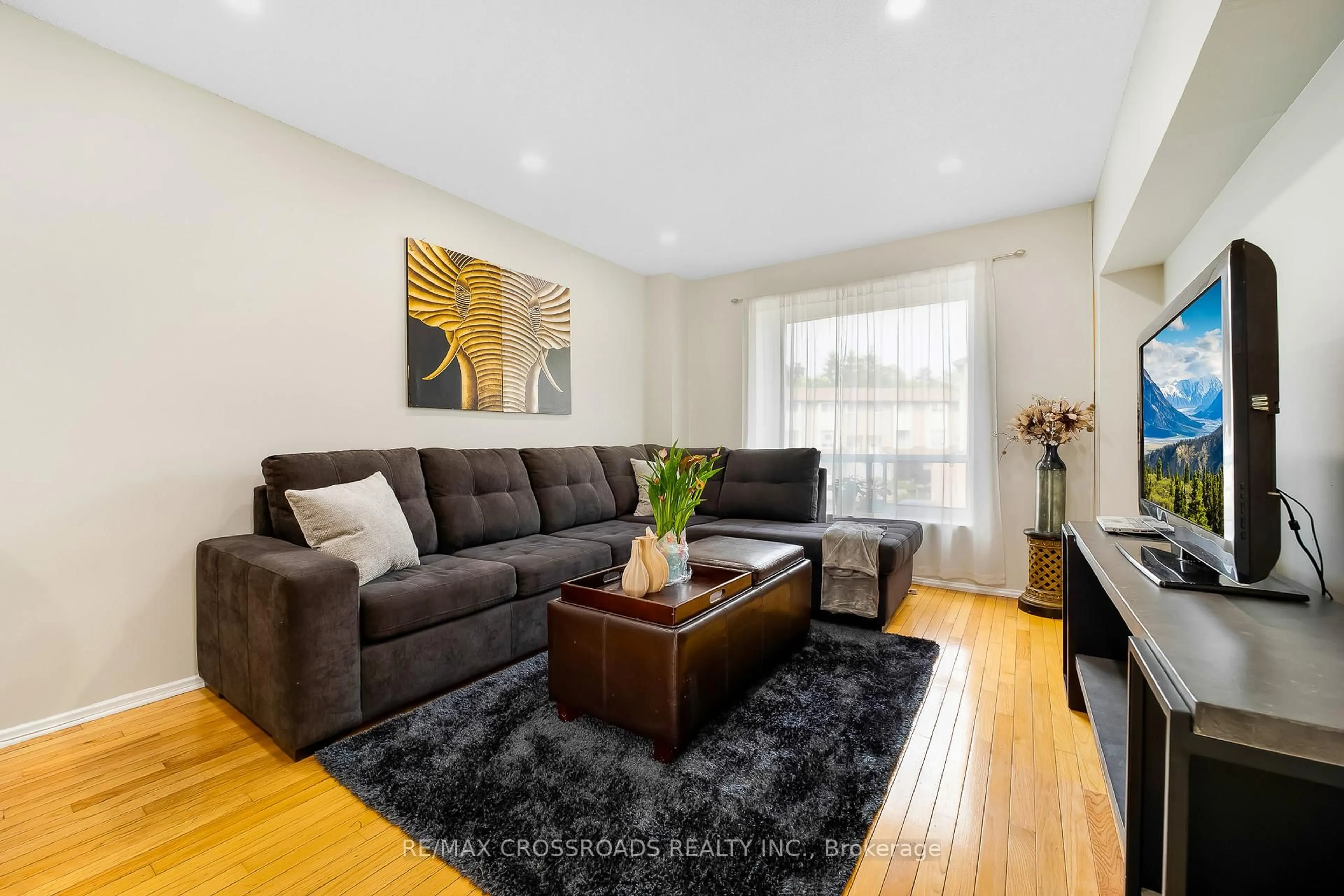 Living room with furniture, wood/laminate floor for 55 Collingsgrove Rd #299, Toronto Ontario M1E 4Z2