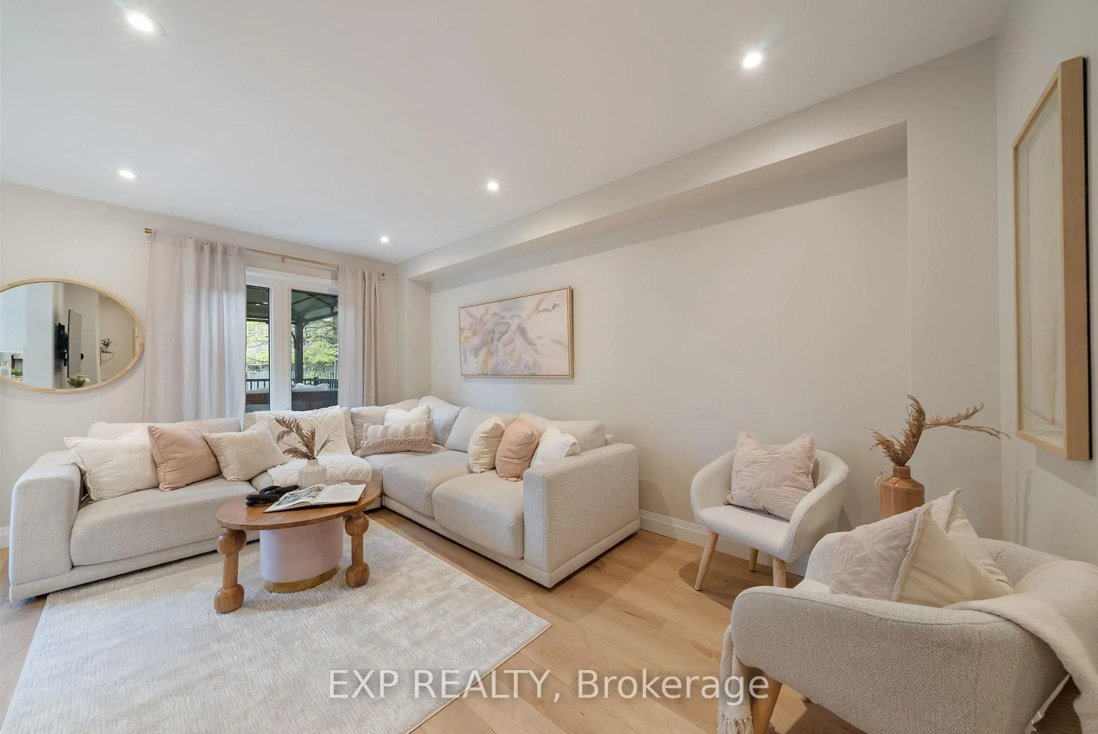 Living room with furniture, wood/laminate floor for 24 Glenmore Dr, Whitby Ontario L1N 9J3