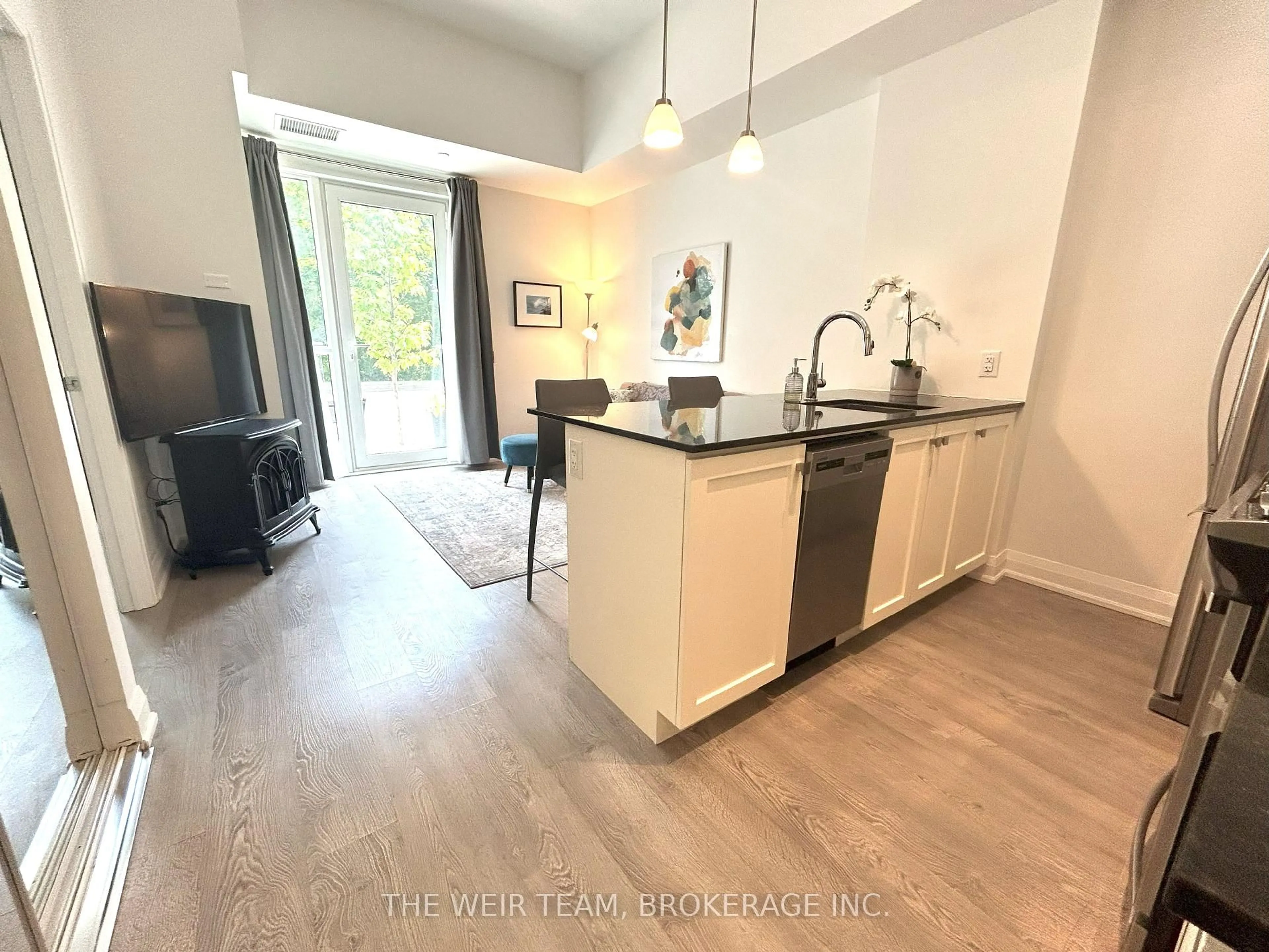 Open concept kitchen, wood/laminate floor for 1400 Kingston Rd #101, Toronto Ontario M1N 0C2
