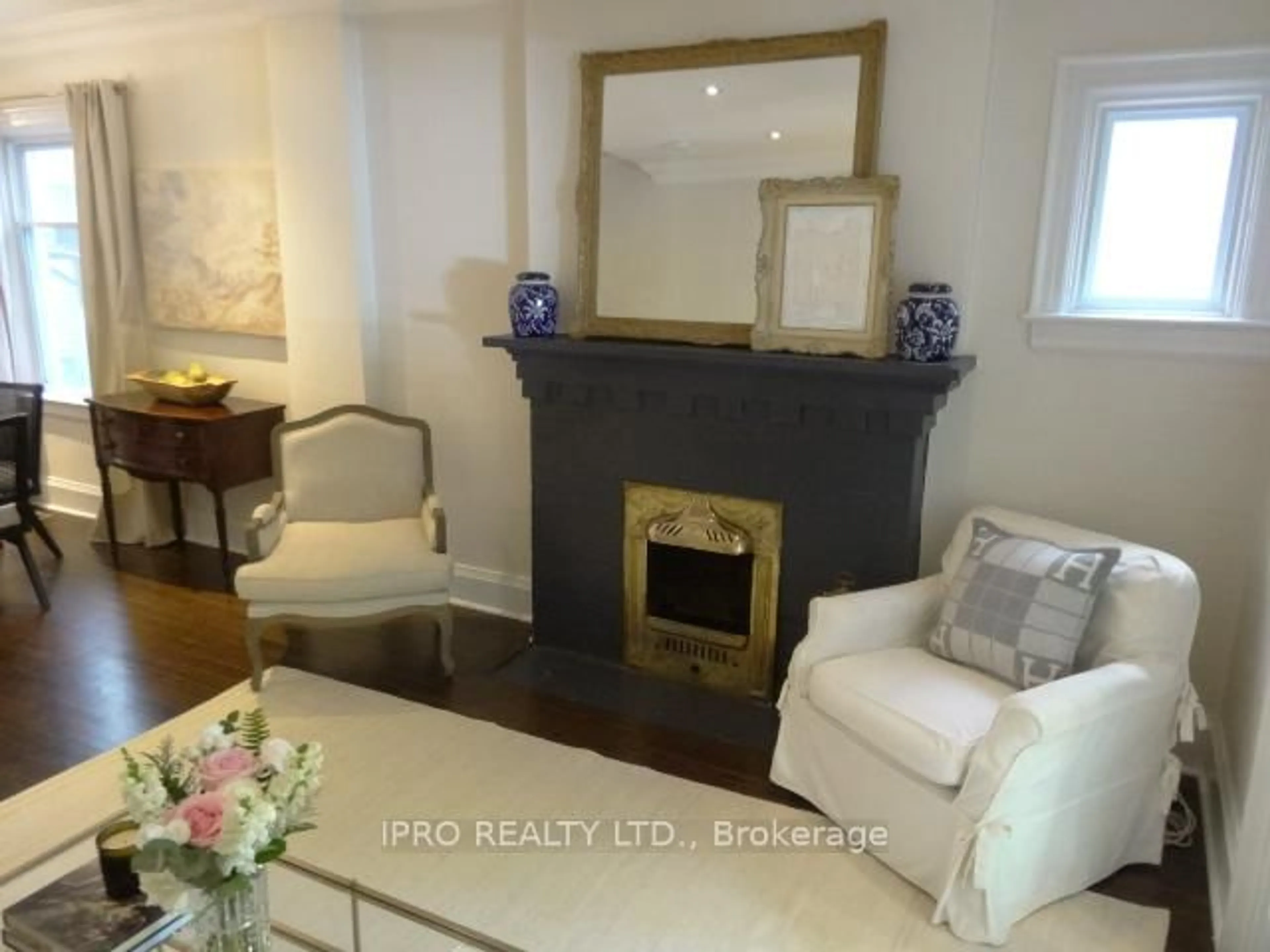 Living room with furniture, wood/laminate floor for 86 Bertmount Ave, Toronto Ontario M4M 2X9