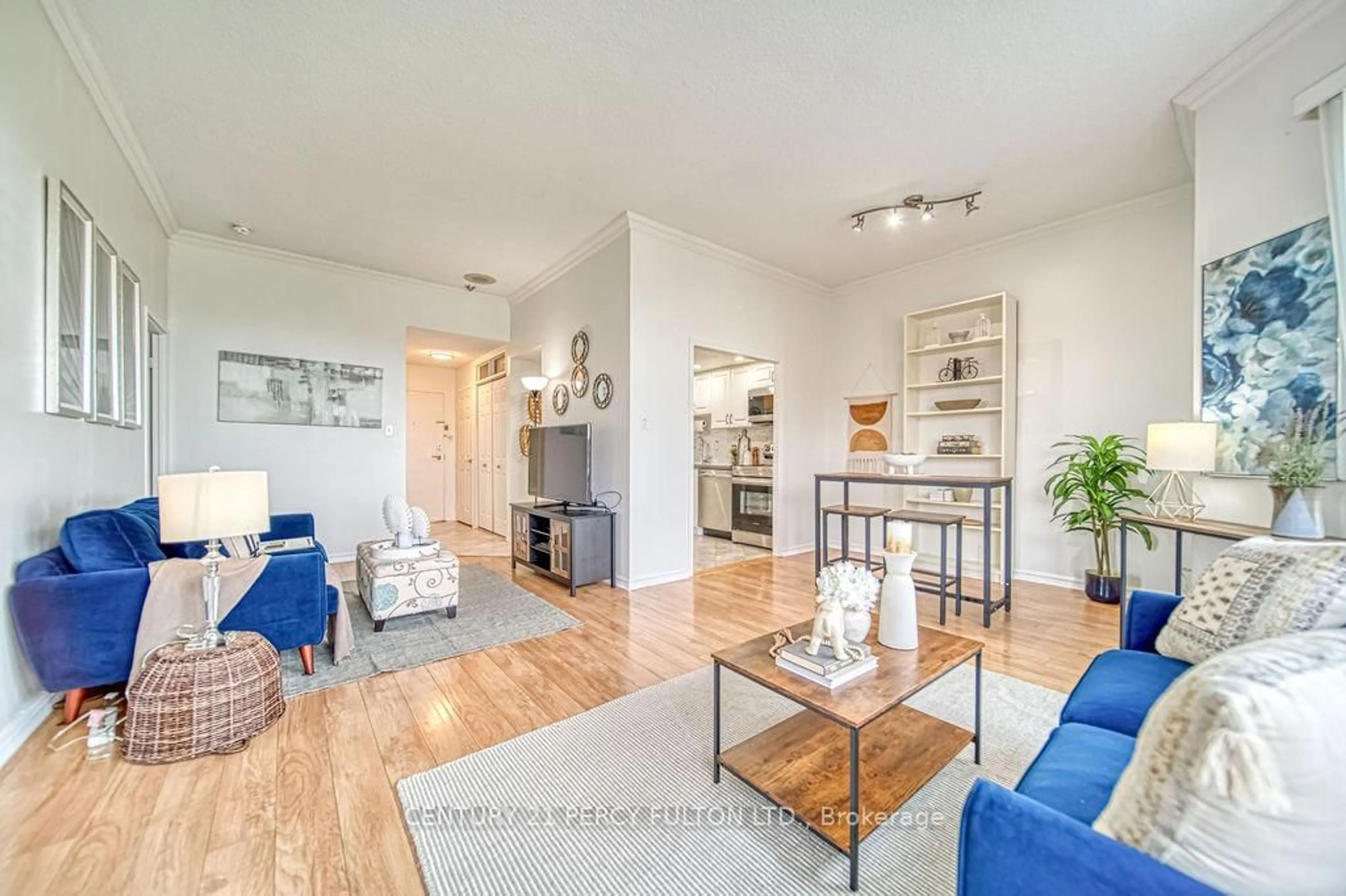 Living room with furniture, wood/laminate floor for 20 Dean Park Rd #1215, Toronto Ontario M1B 3G9