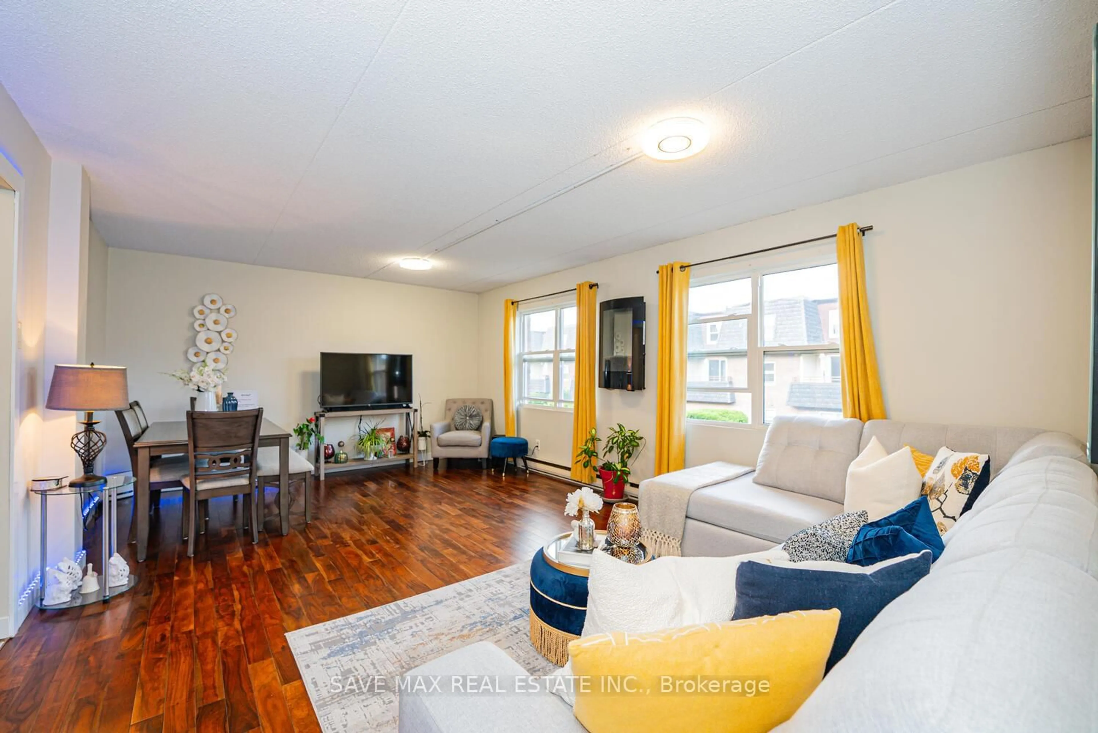 Living room with furniture, wood/laminate floor for 580 Mary St #214, Whitby Ontario L1N 2R3