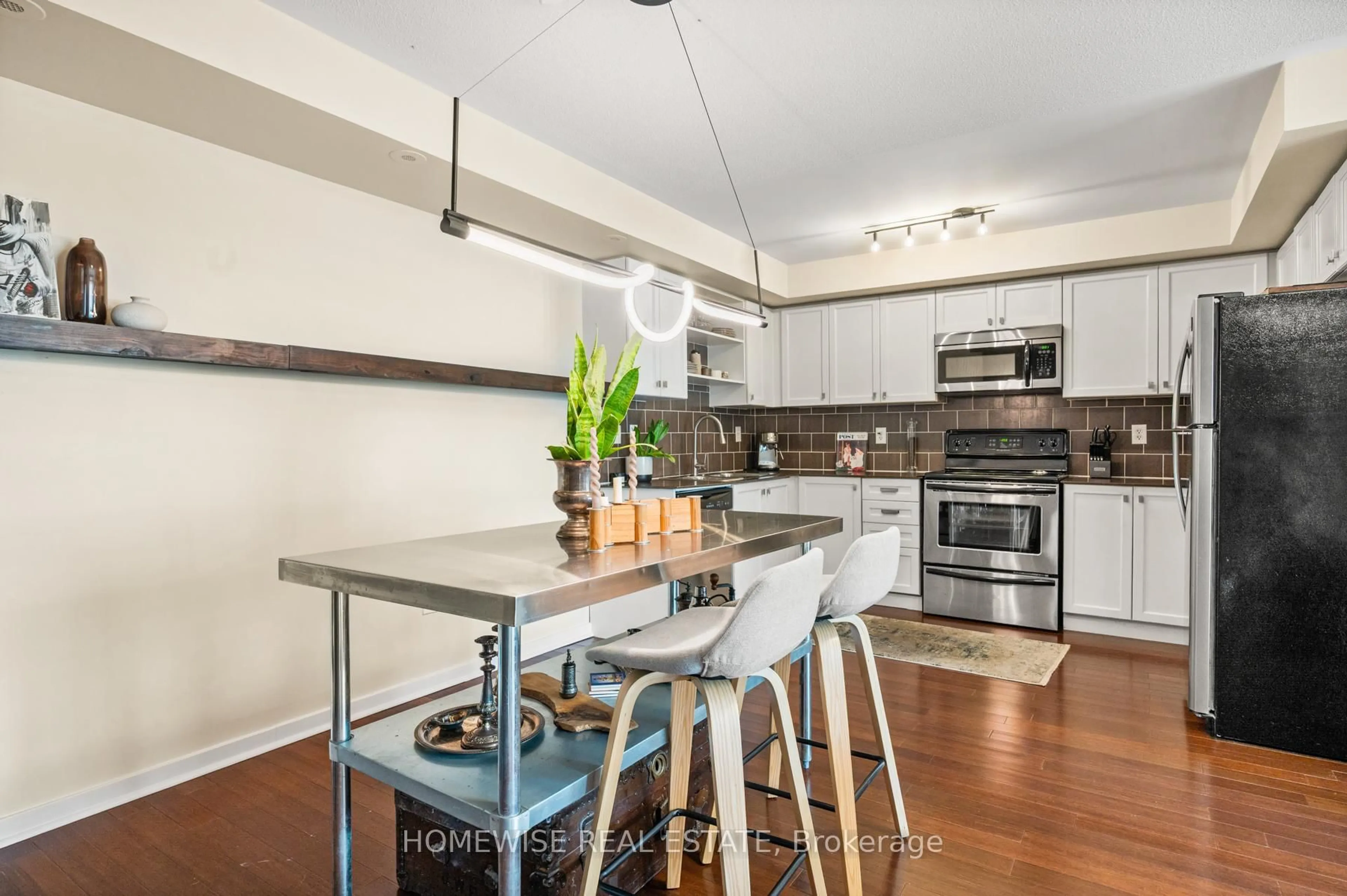 Open concept kitchen, wood/laminate floor for 63 Carroll St, Toronto Ontario M4M 3G2