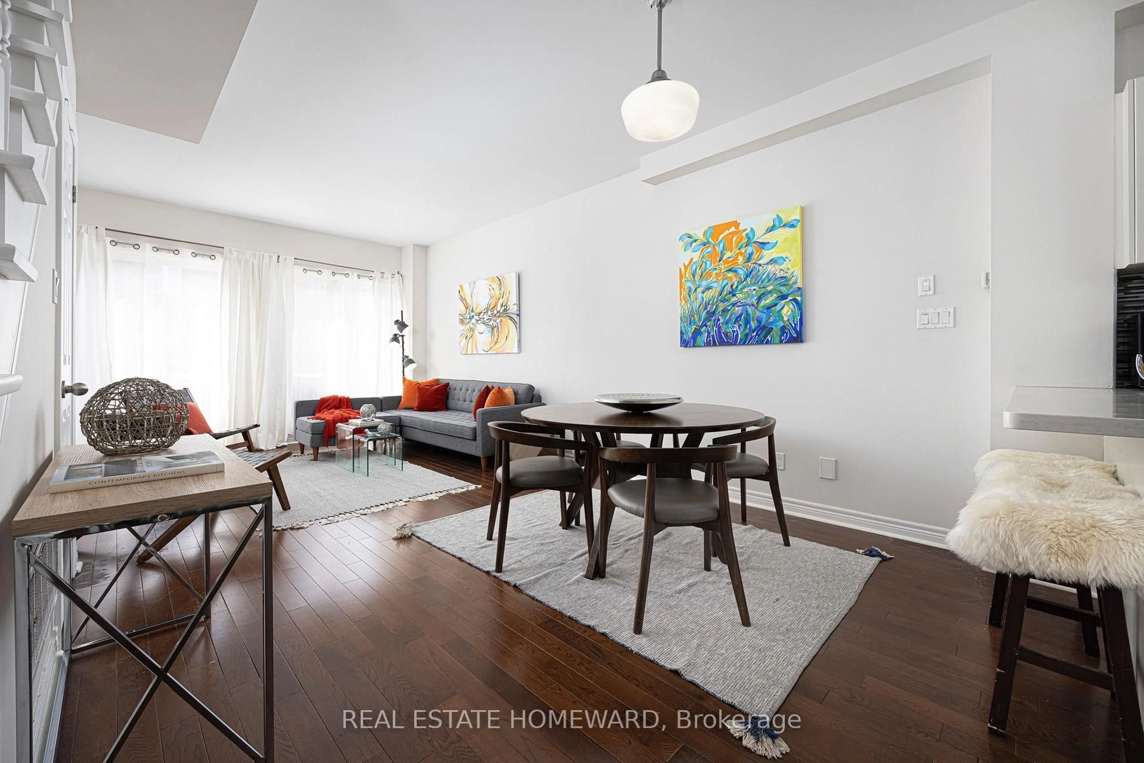 Living room with furniture, wood/laminate floor for 3773 St. Clair Ave, Toronto Ontario M1M 1V1
